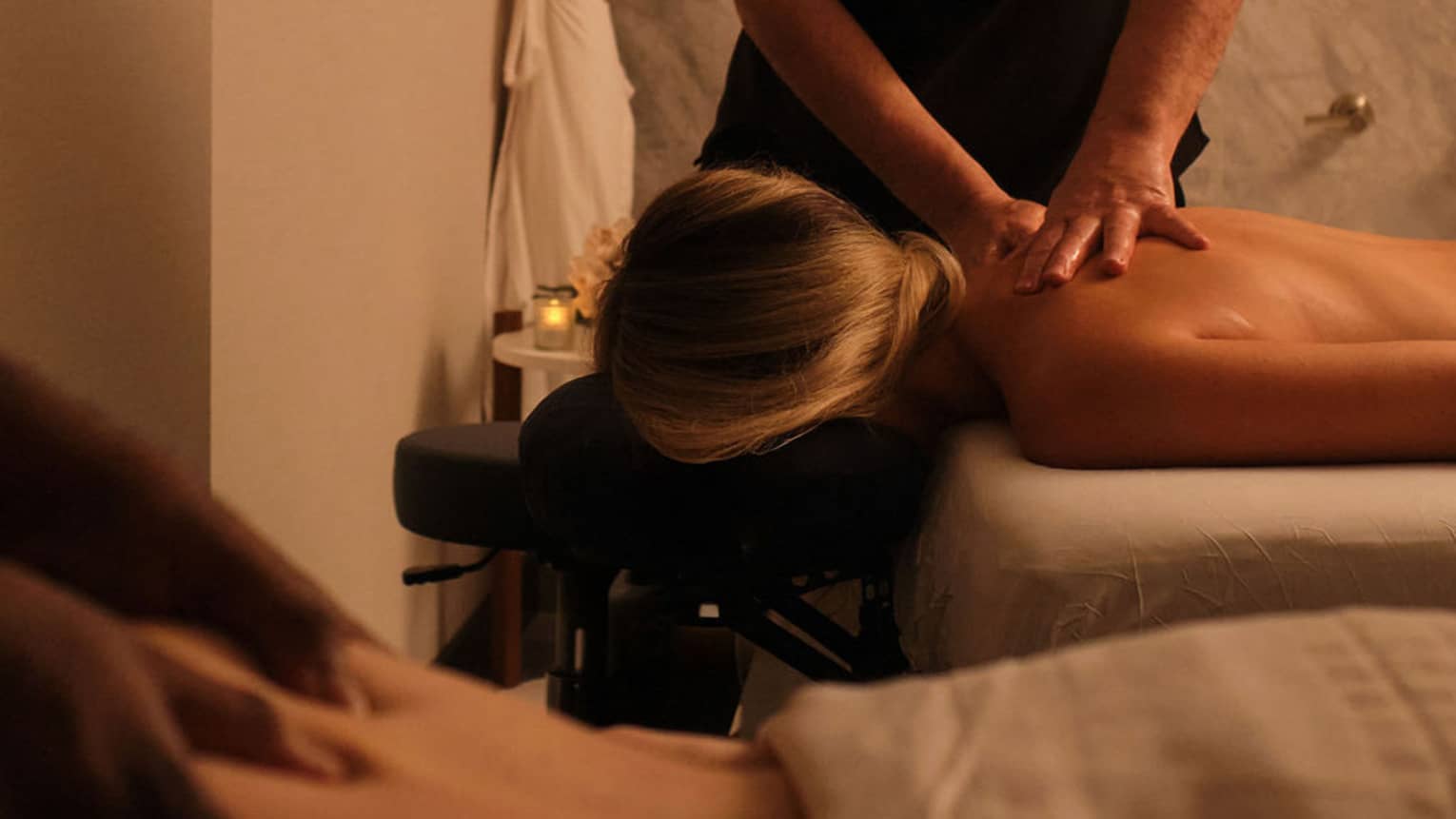 Couple getting side-by-side massages