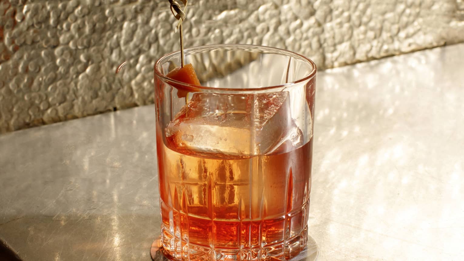 A glass of alcohol on a counter.