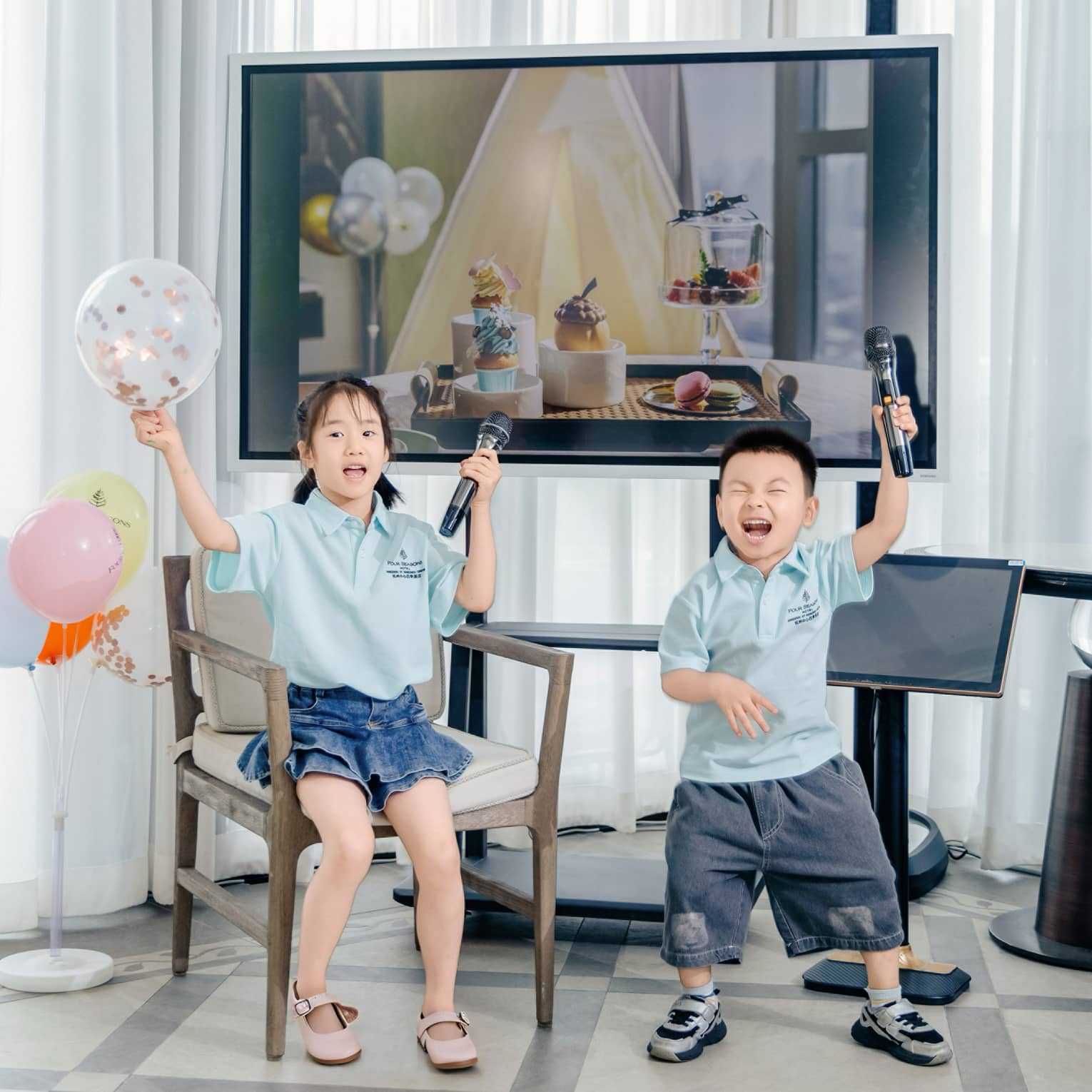 Two young children get ready for karaoke