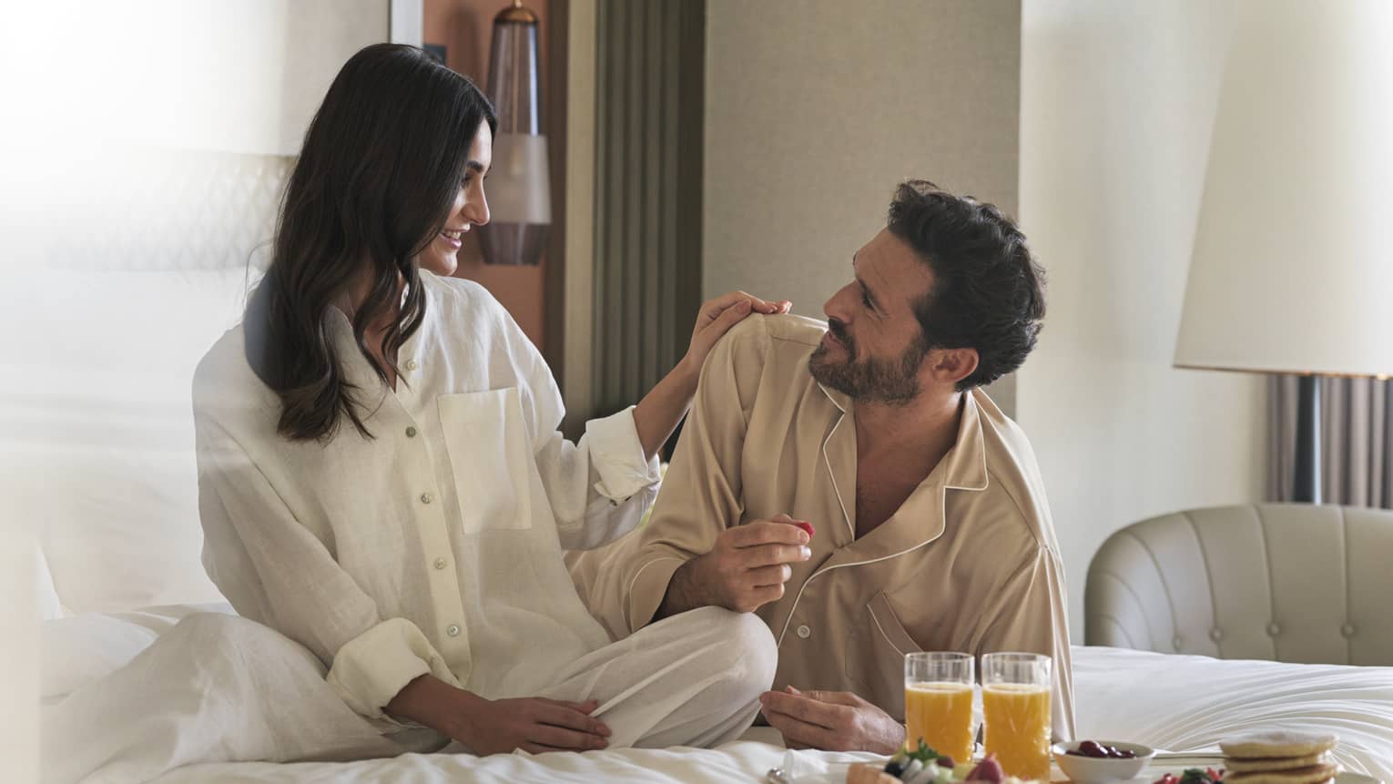 Pajama-clad couple enjoys in-room dining in their guest room