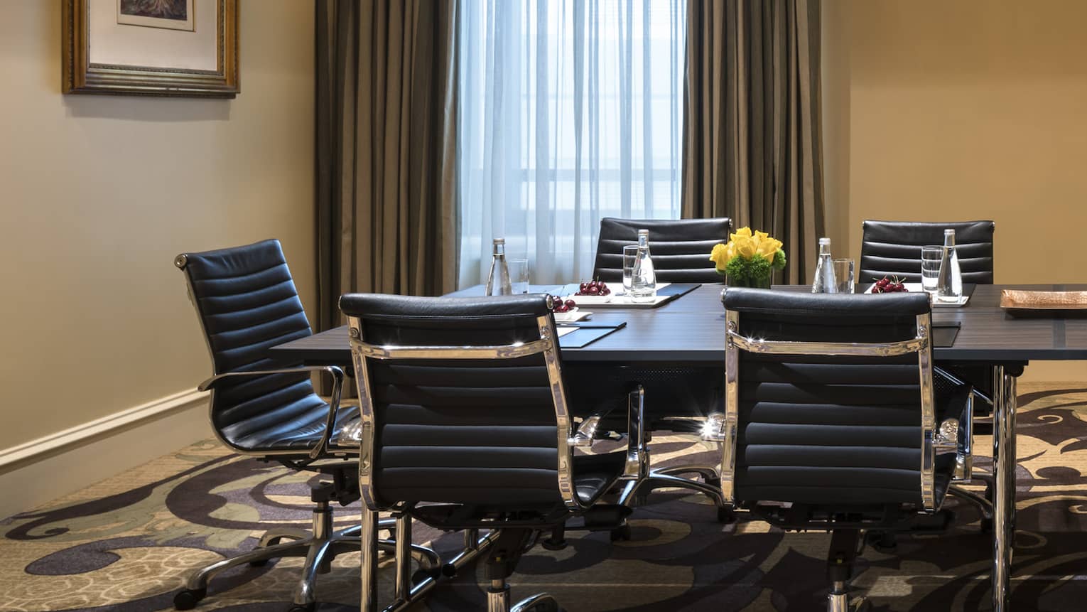 Long boardroom meeting table with leather swivel chairs