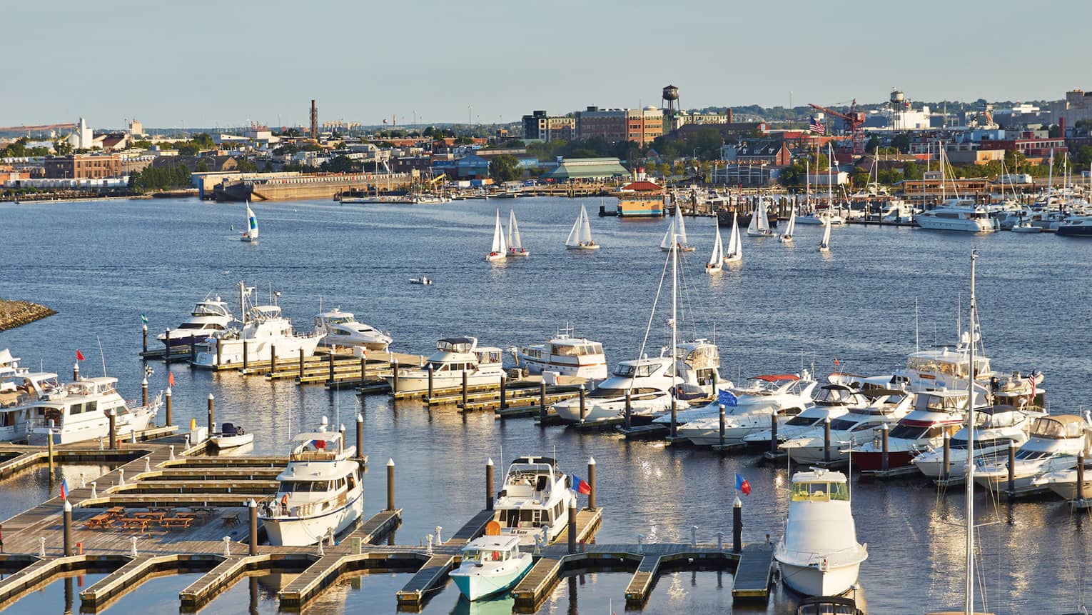 Looking down over boats, docks in Baltimore harbour on sunny day