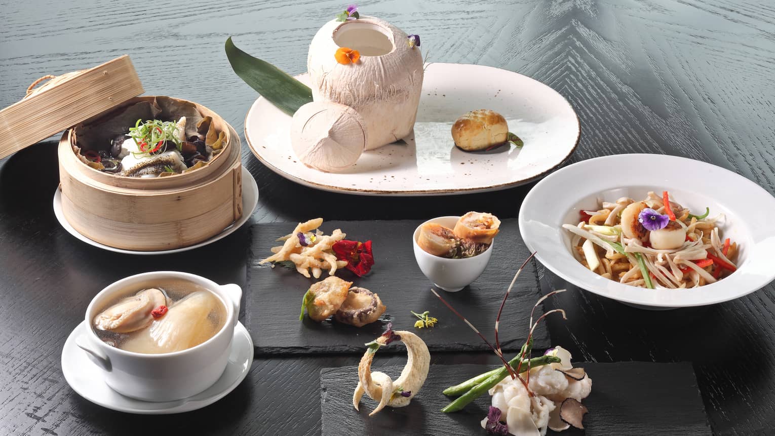 Steam basket, small bowls and platters with gourmet Malaysian and Middle Eastern cuisine