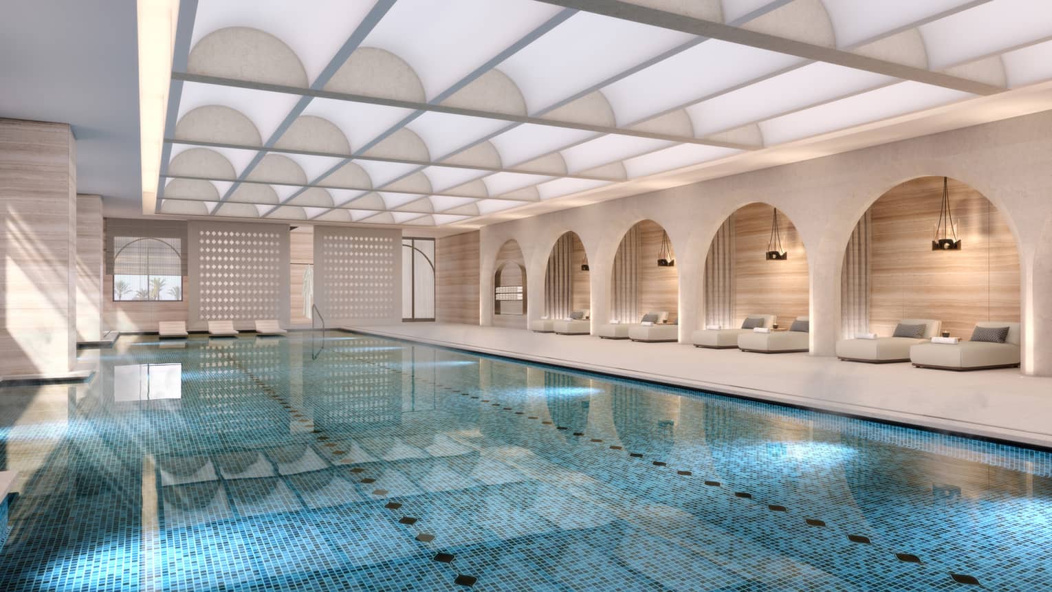 Indoor pool with daybeds lining the wall