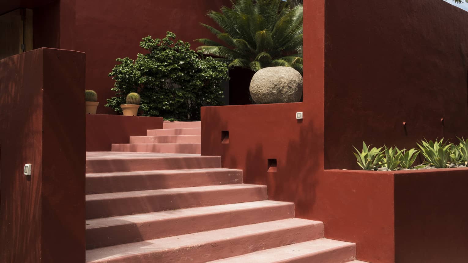 Stairs to entrance of red stucco villa