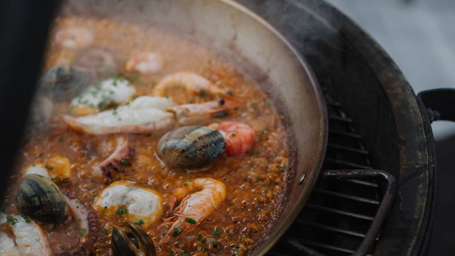 Paella cooking on grill