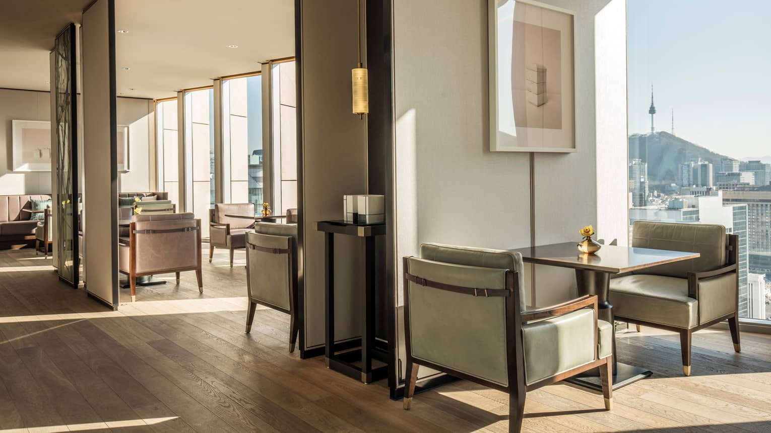 Sunny Dining Room with lounge tables, chairs, large windows with city views