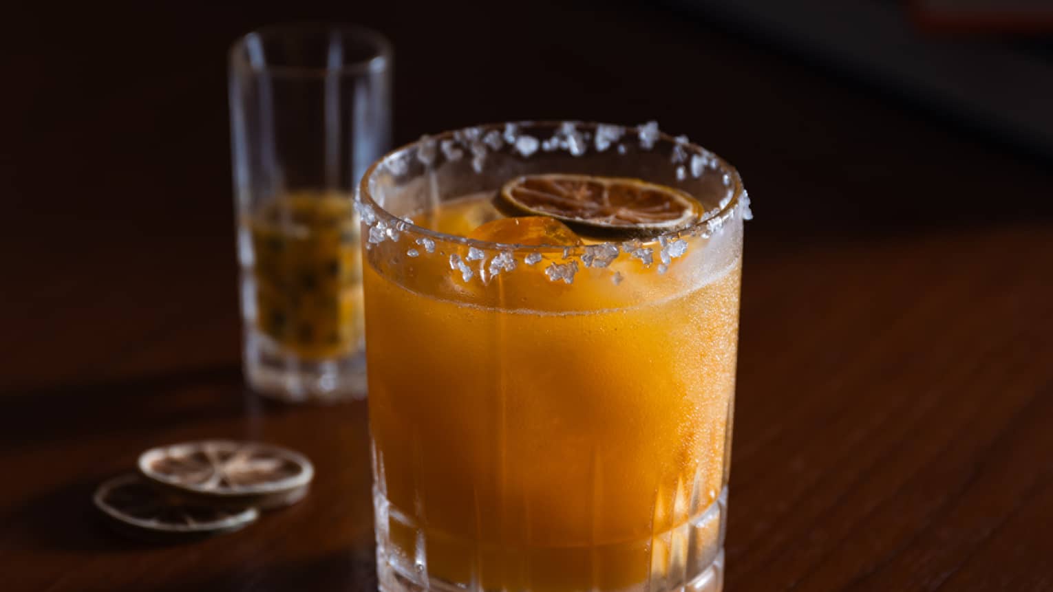 Drink with ice around the rim and orange slice on top.