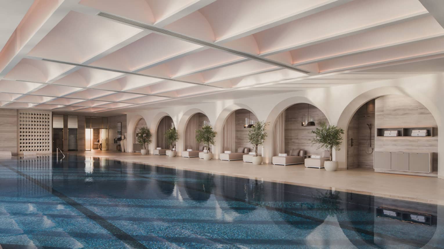 Large indoor swimming pool with pool lounge chairs