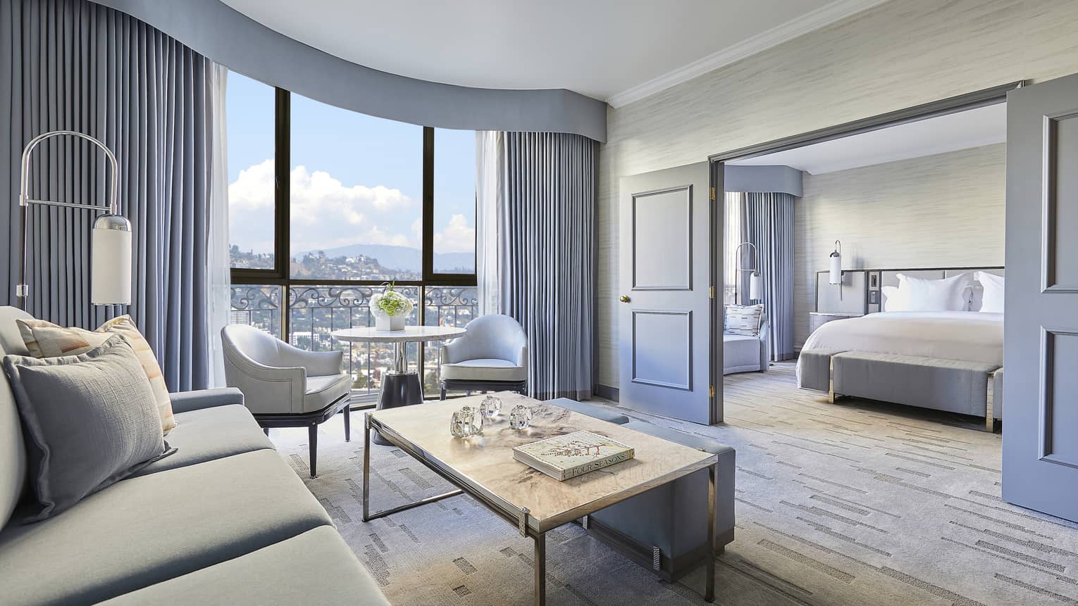 Hotel suite living room with sliding doors to bedroom