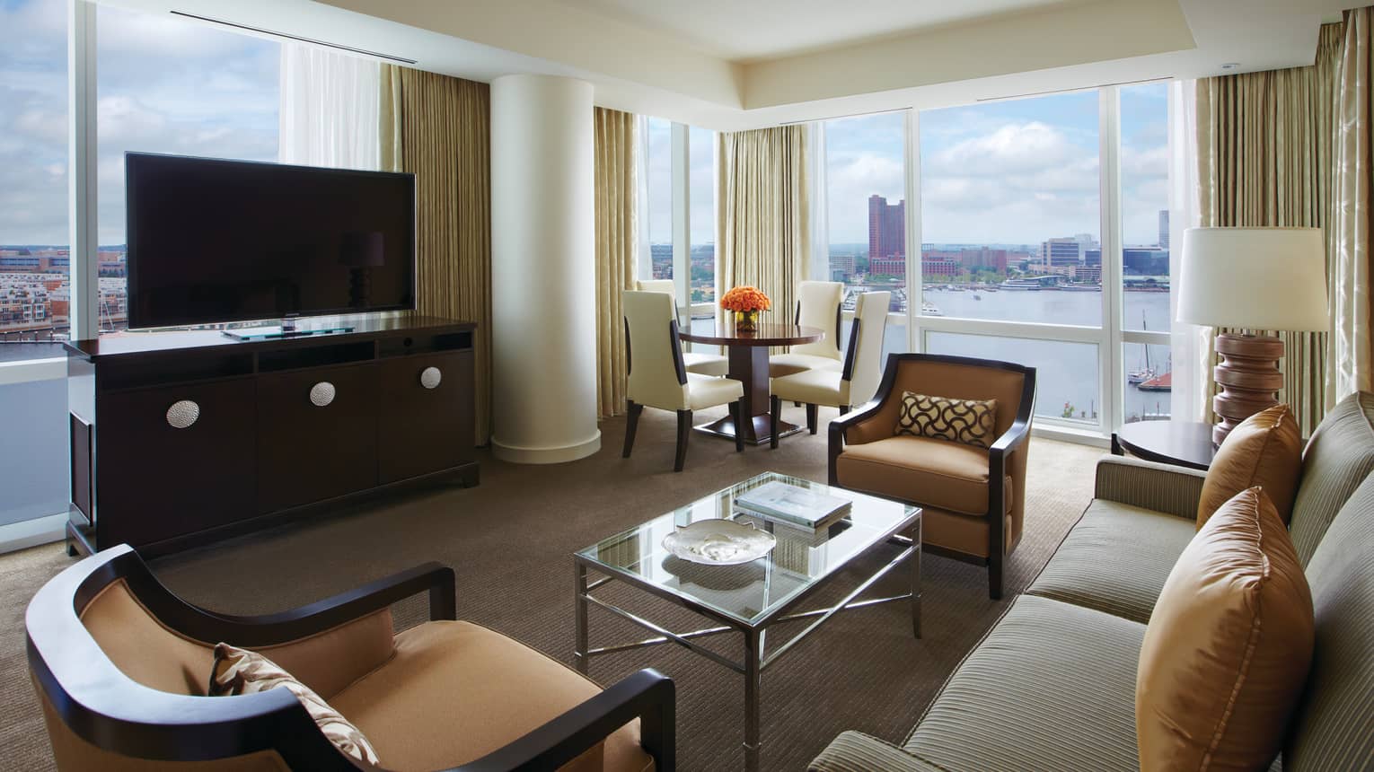 Harbour Suite loveseat, armchairs, dresser and TV in front of window overlooking water