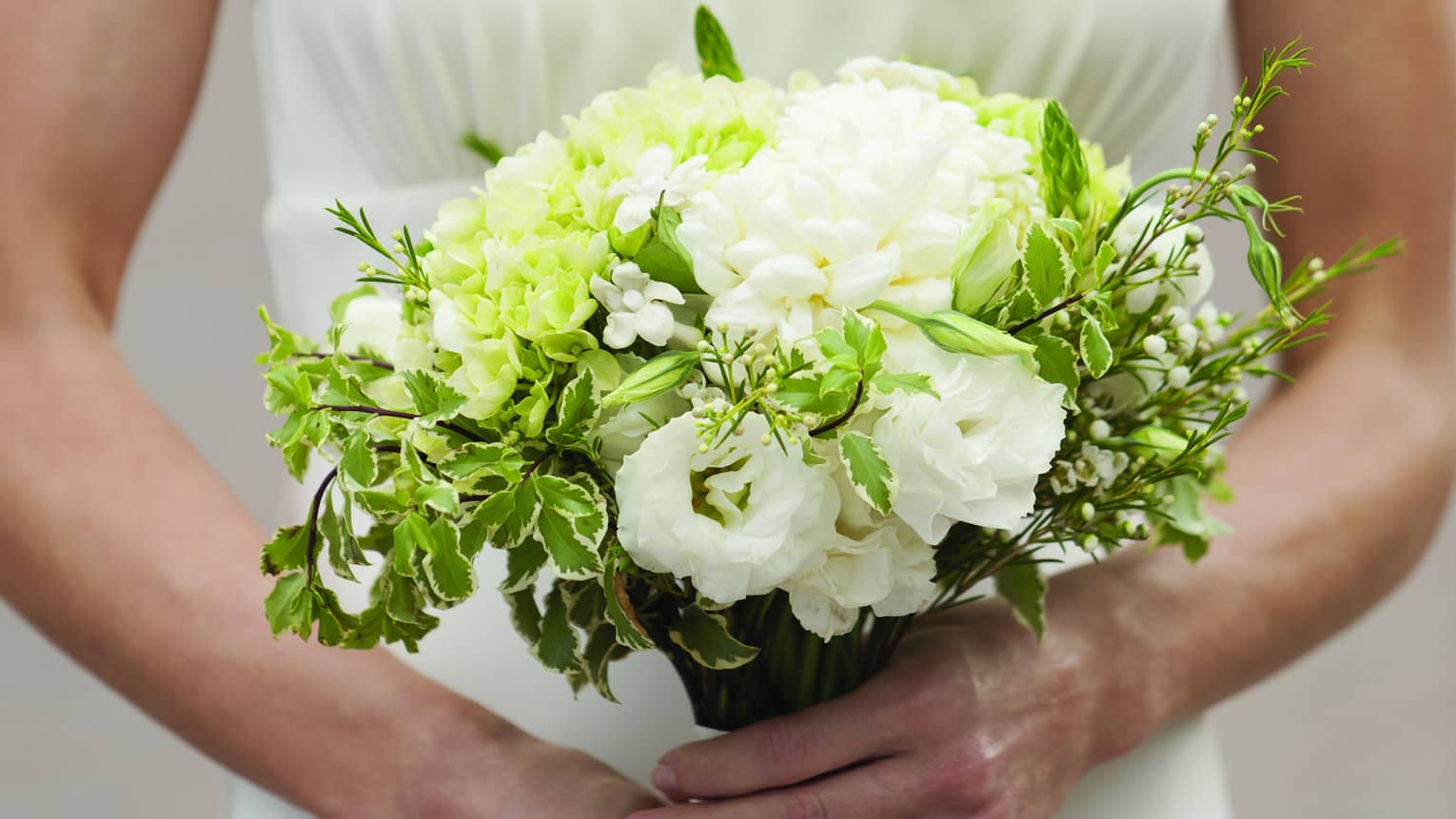 Bride holding white floral wedding bouquet