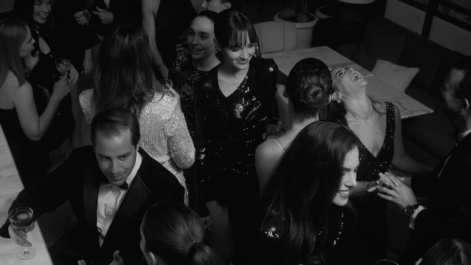 People laughing and socializing at hotel bar