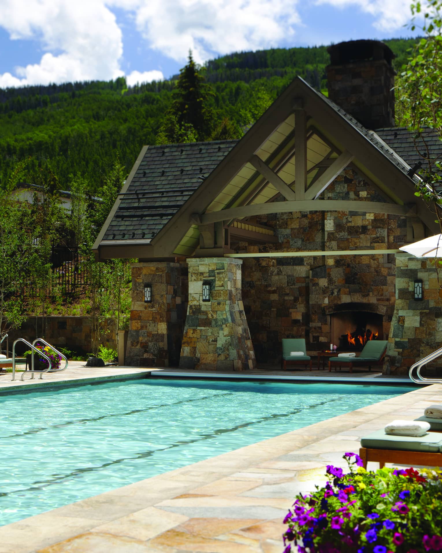 Outdoor lap pool at Four Seasons Resort Vail, lined with lounge chairs