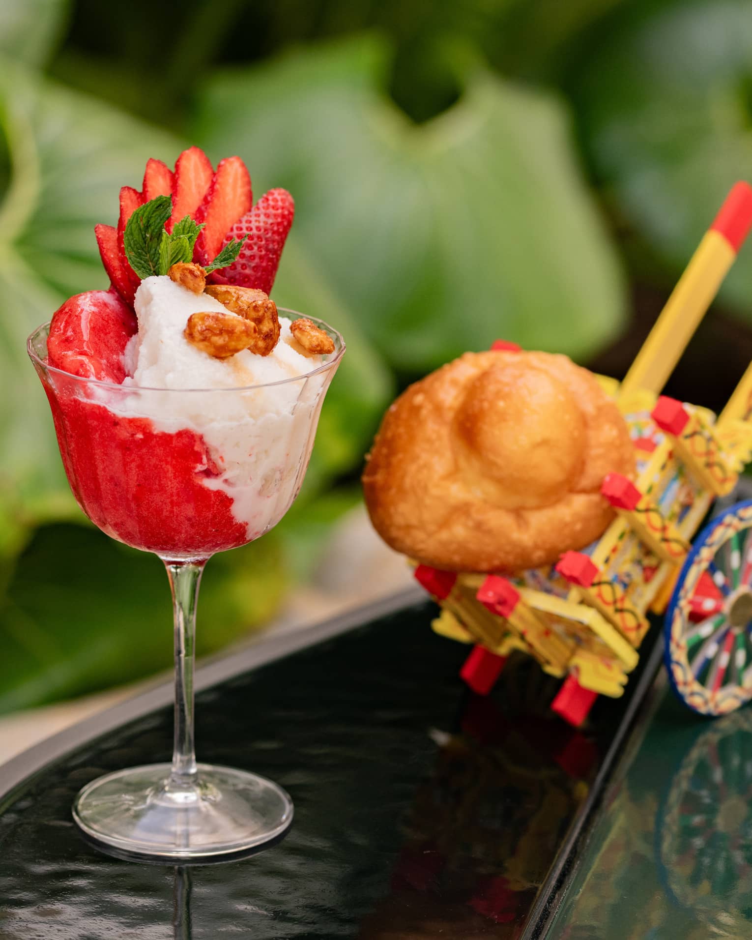 Red-and-white granita topped with sliced strawberry in fluted glass