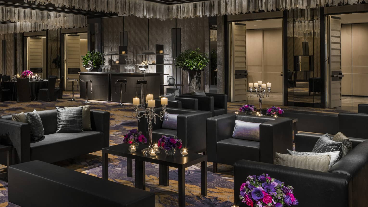 Modern Nuri Ballroom with black furniture, black dining tables, bright flowers and candles