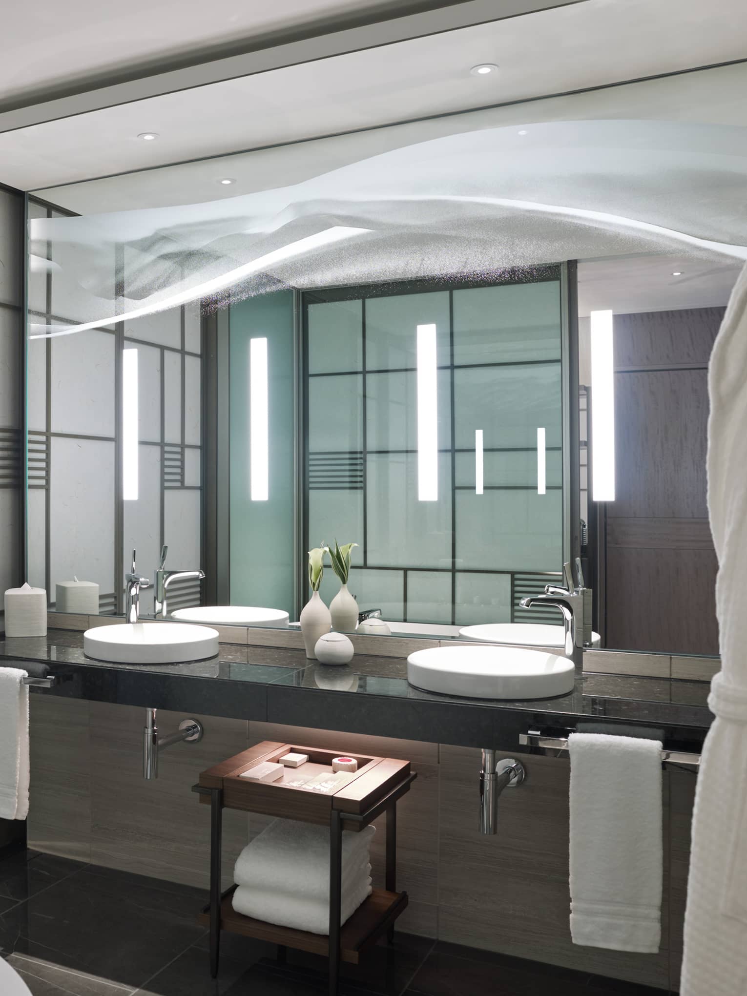 Modern bathroom with a double-sink vanity, large mirror and sleek accent lighting, featuring light-coloured panelled walls