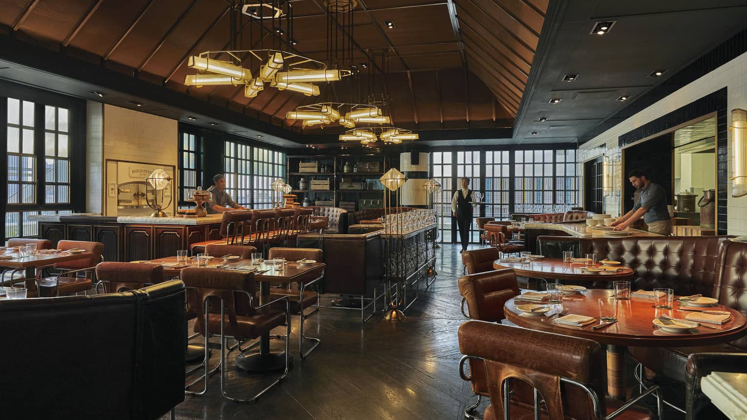 Restaurant and bar with brown leather seats and sofas, bar stools and contemporary lights