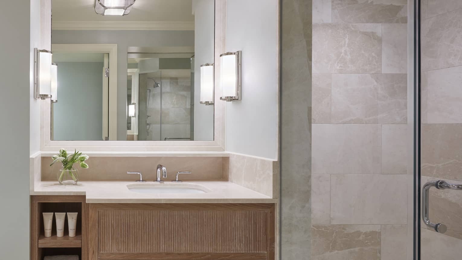 Modern hotel bathroom with a tub and marble walls