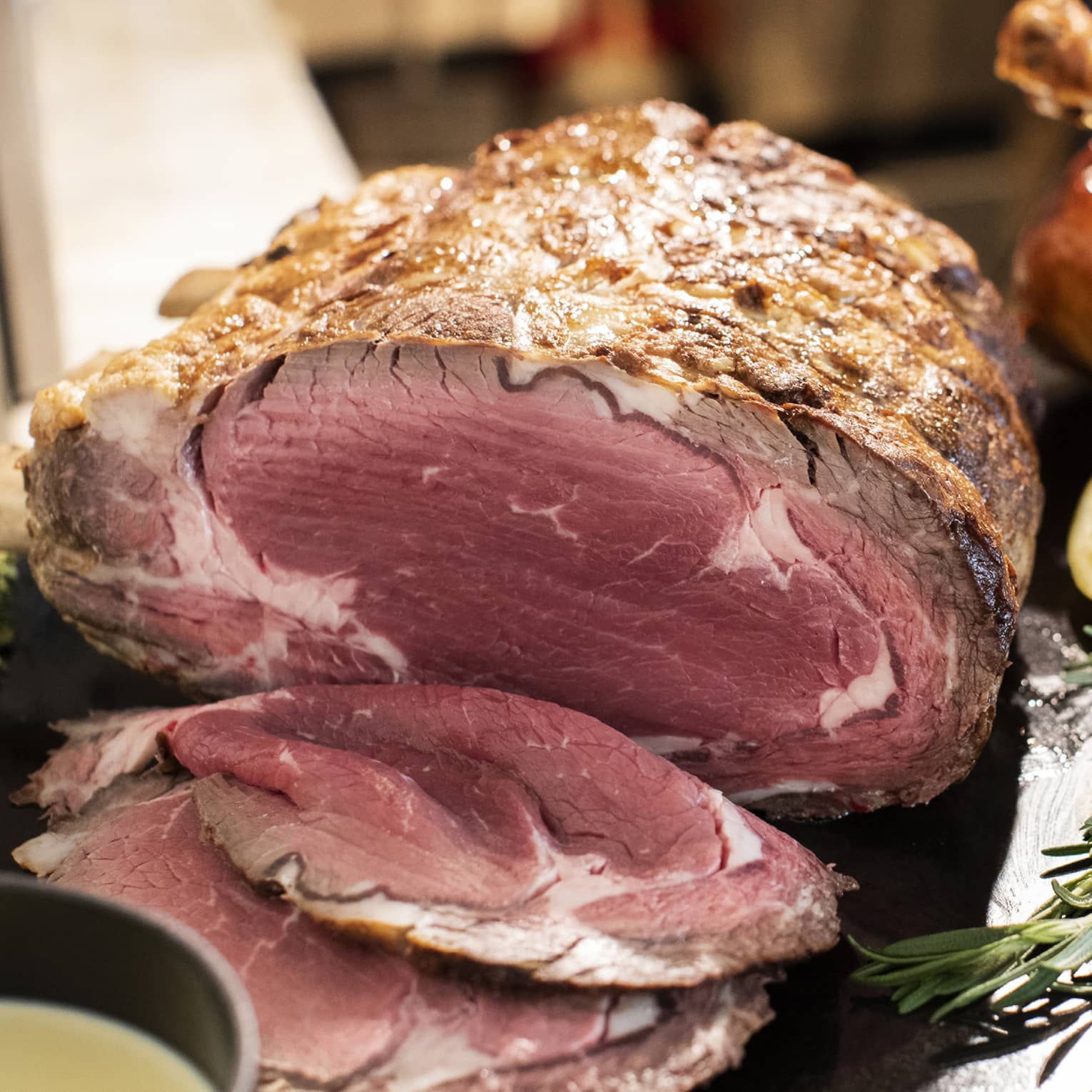 Holiday prime rib, whole turkey and side of salmon on black display board