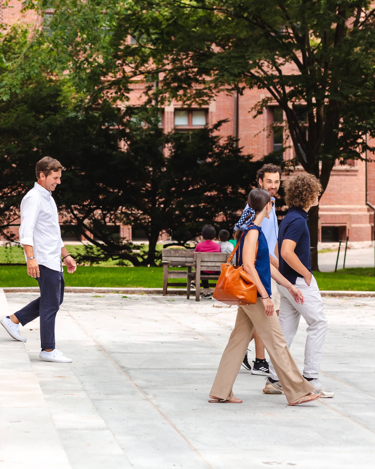 A family walking down steps in a park like area.