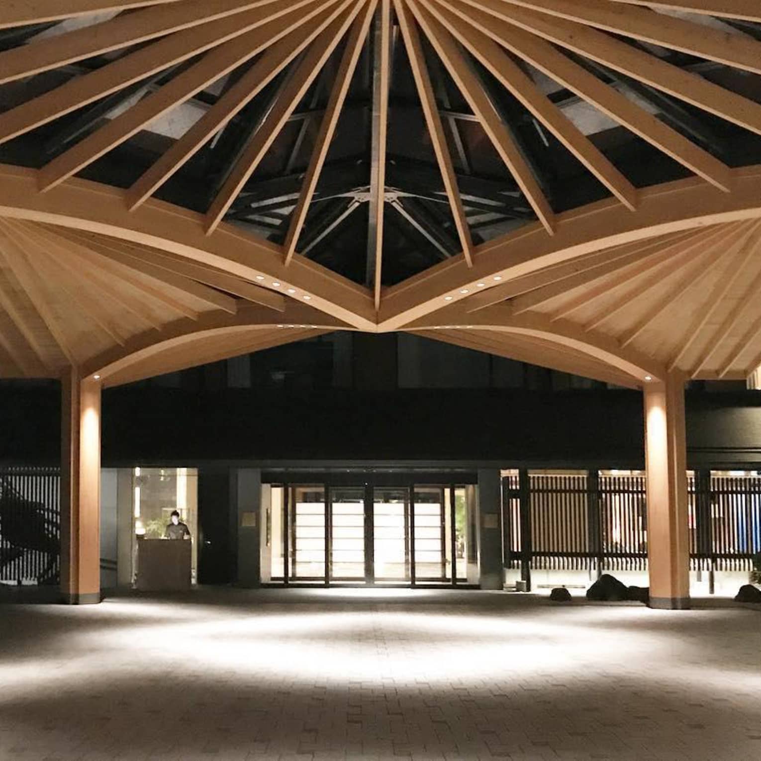 Illuminated wooden pavilion structure at the entrance courtyard of Four Seasons