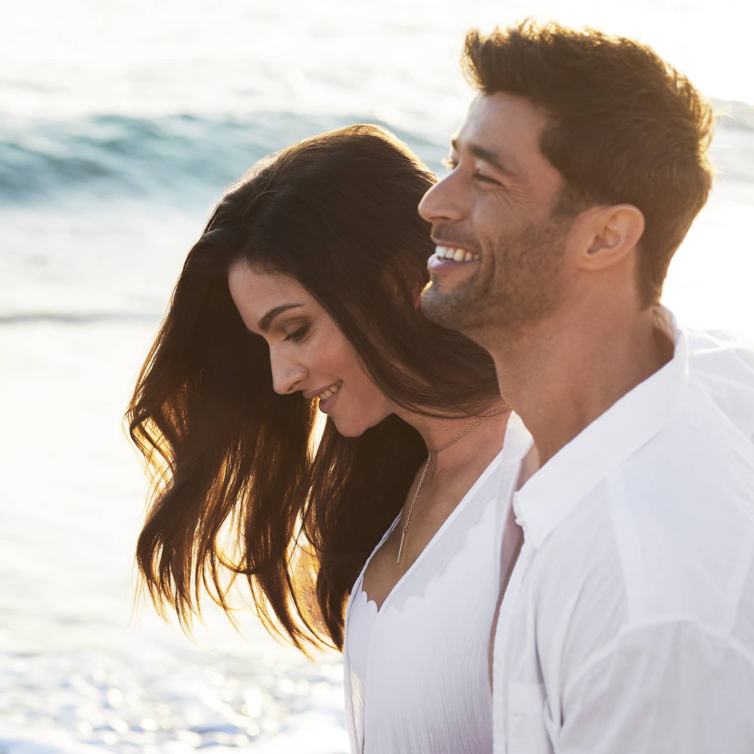 Man and woman walk on the beach