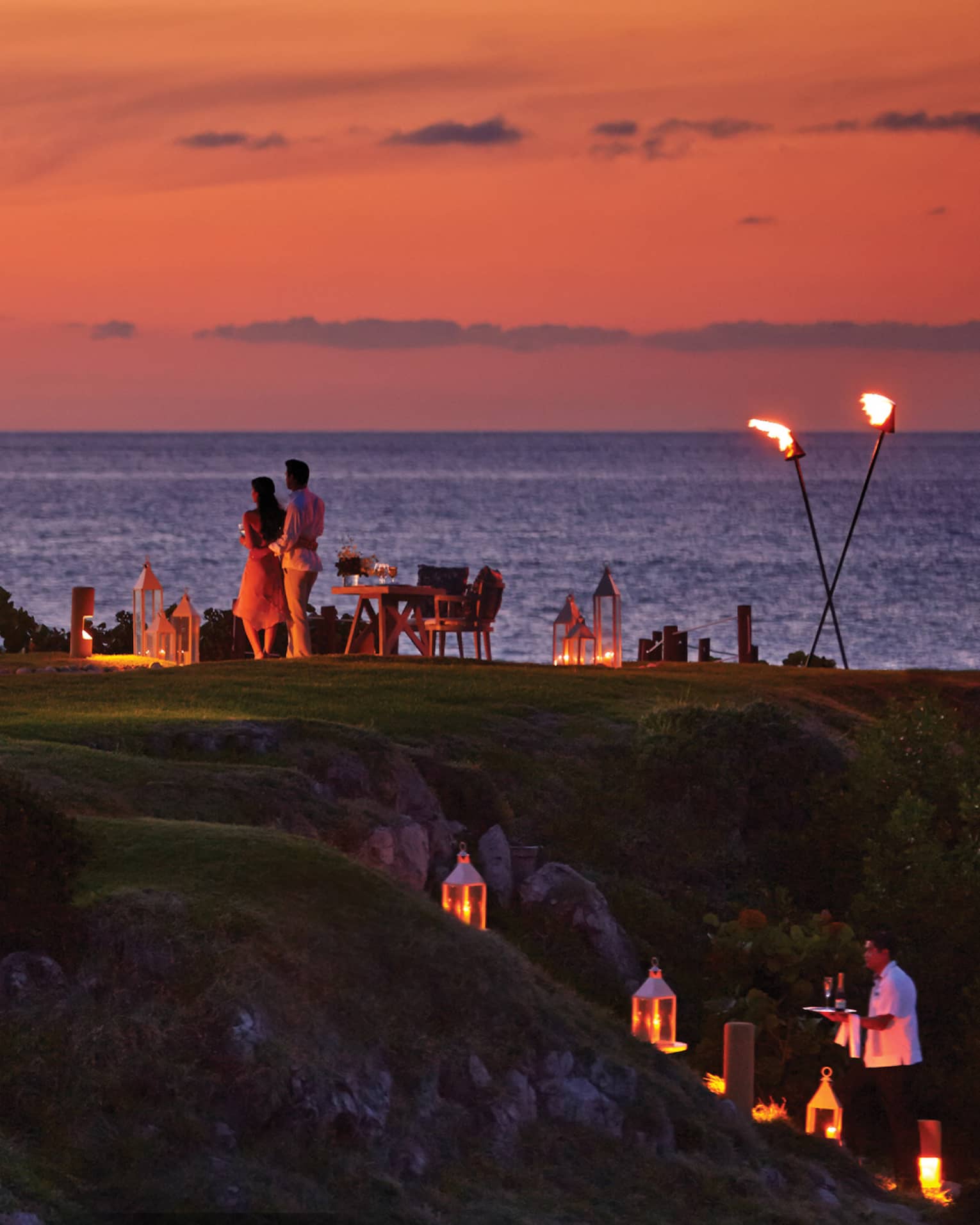 ,A group gathered for dinner outside during sunet.
