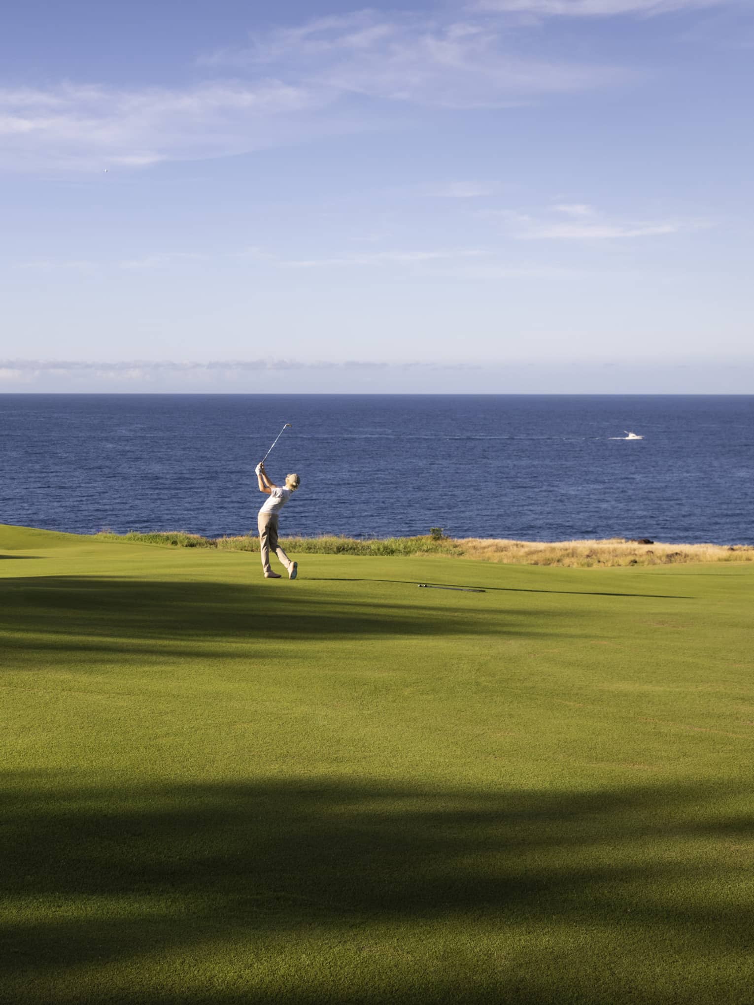 Golfer on oceanside fairway at Four Seasons Resort Lanai