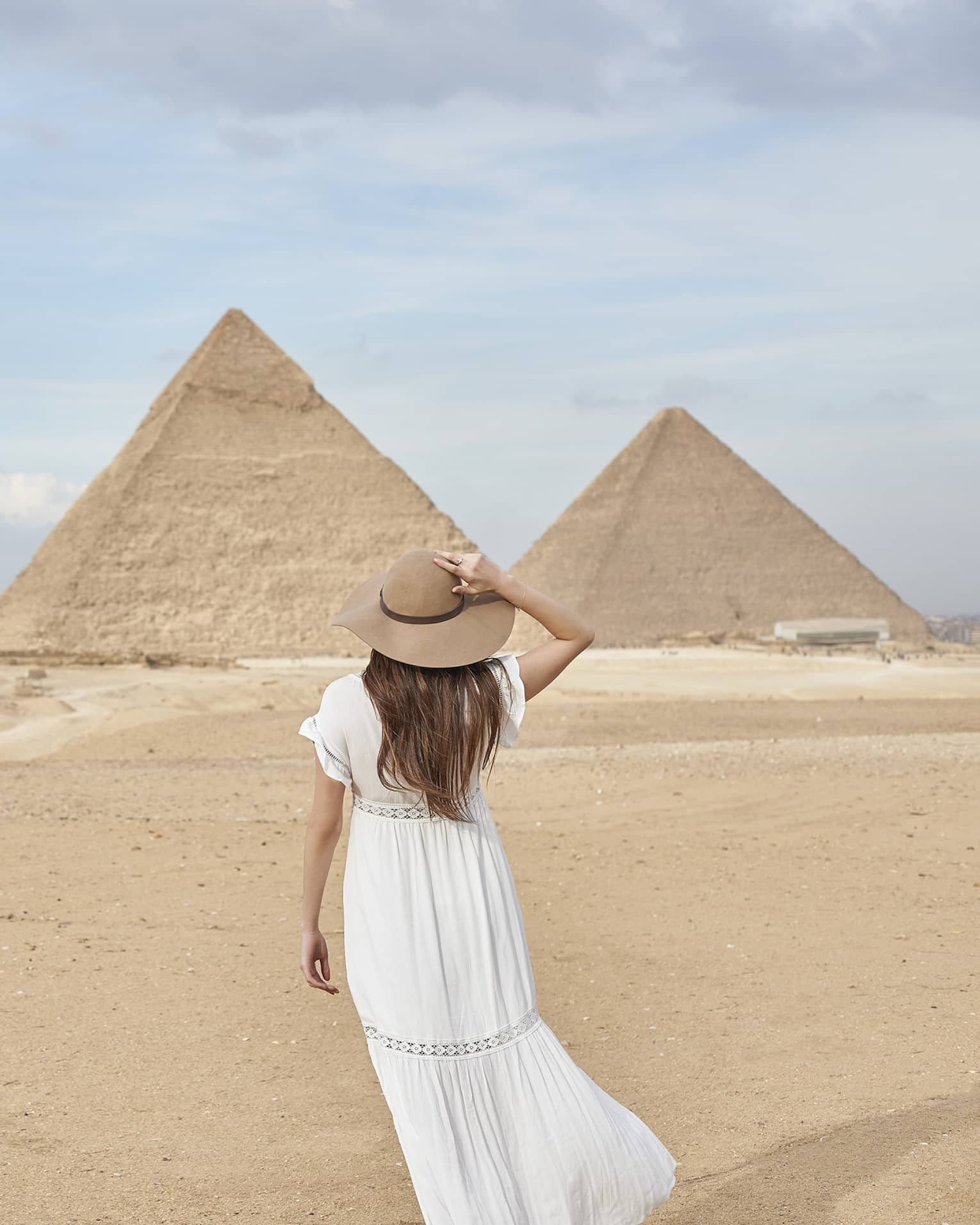 A guest wearing a linen dress observing the Great Pyramids