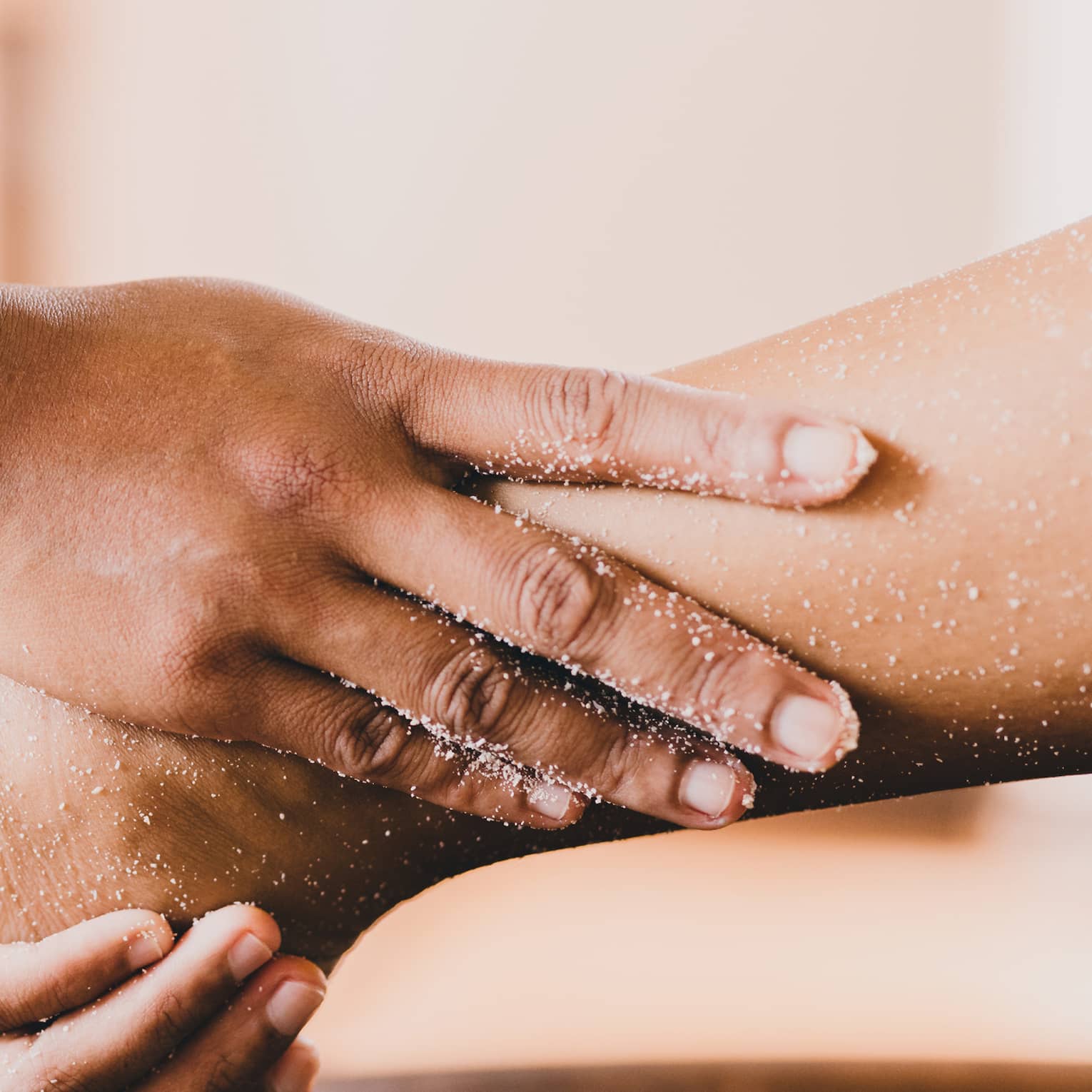 Hands hold a person's foot and ankle in a spa