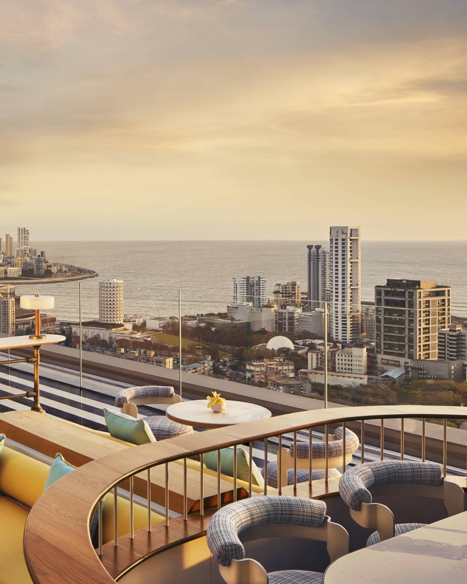 AER rooftop lounge at sunrise with views of Mumbai's skyline
