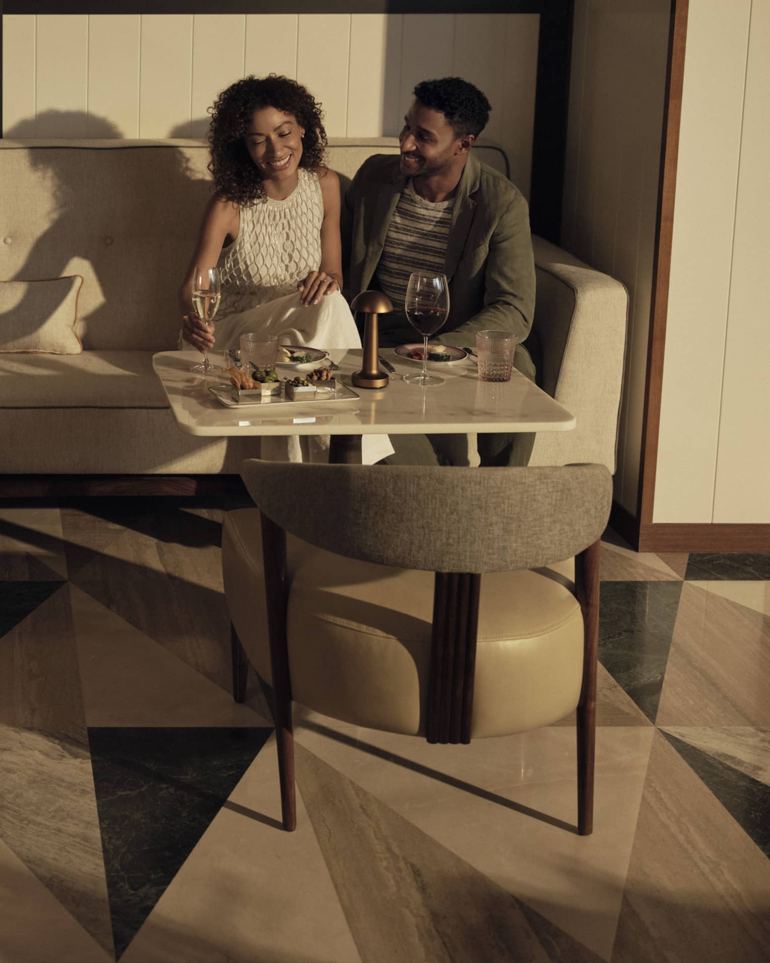 Man and woman enjoy a wine tasting at Honey Fitz