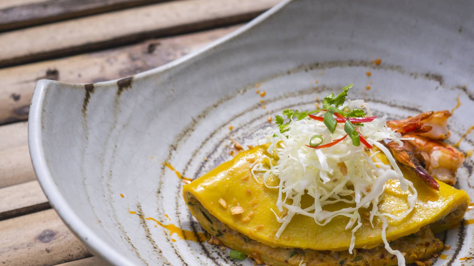 Asian dish with garnish served in pottery bowl 
