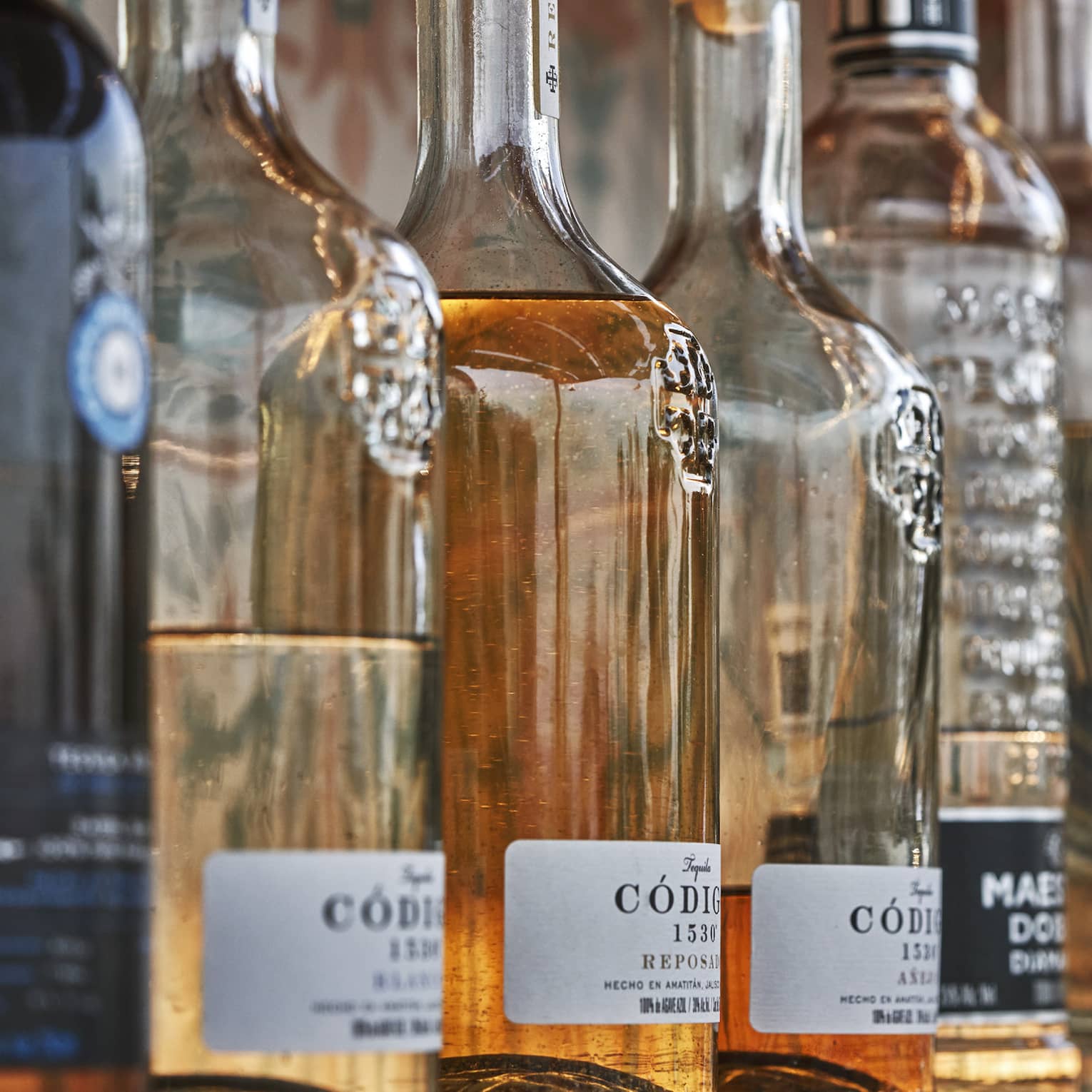 A row of wine and liquor bottles on a shelf.