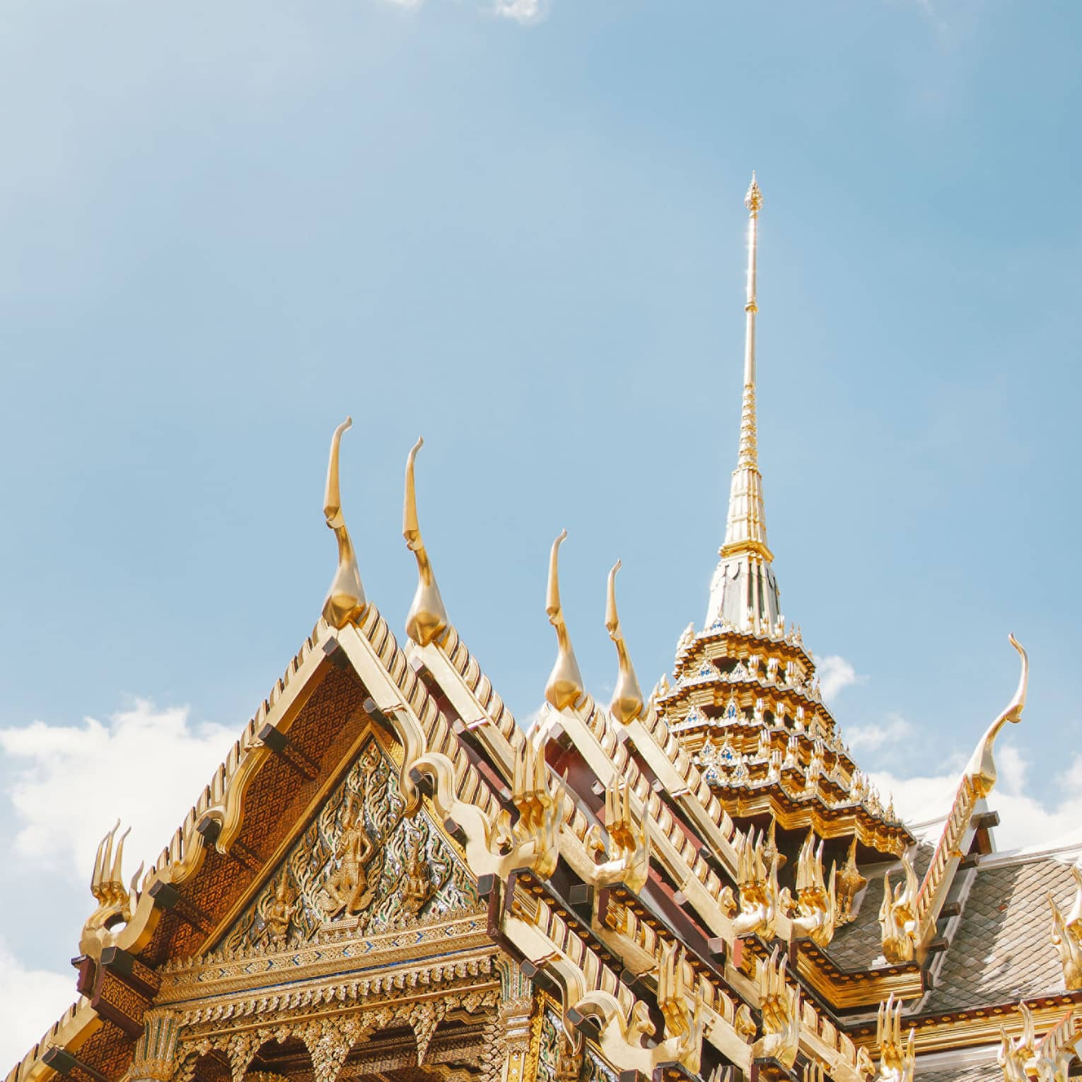 Wat Ratchabophit temple architecture against blue sky, white clouds