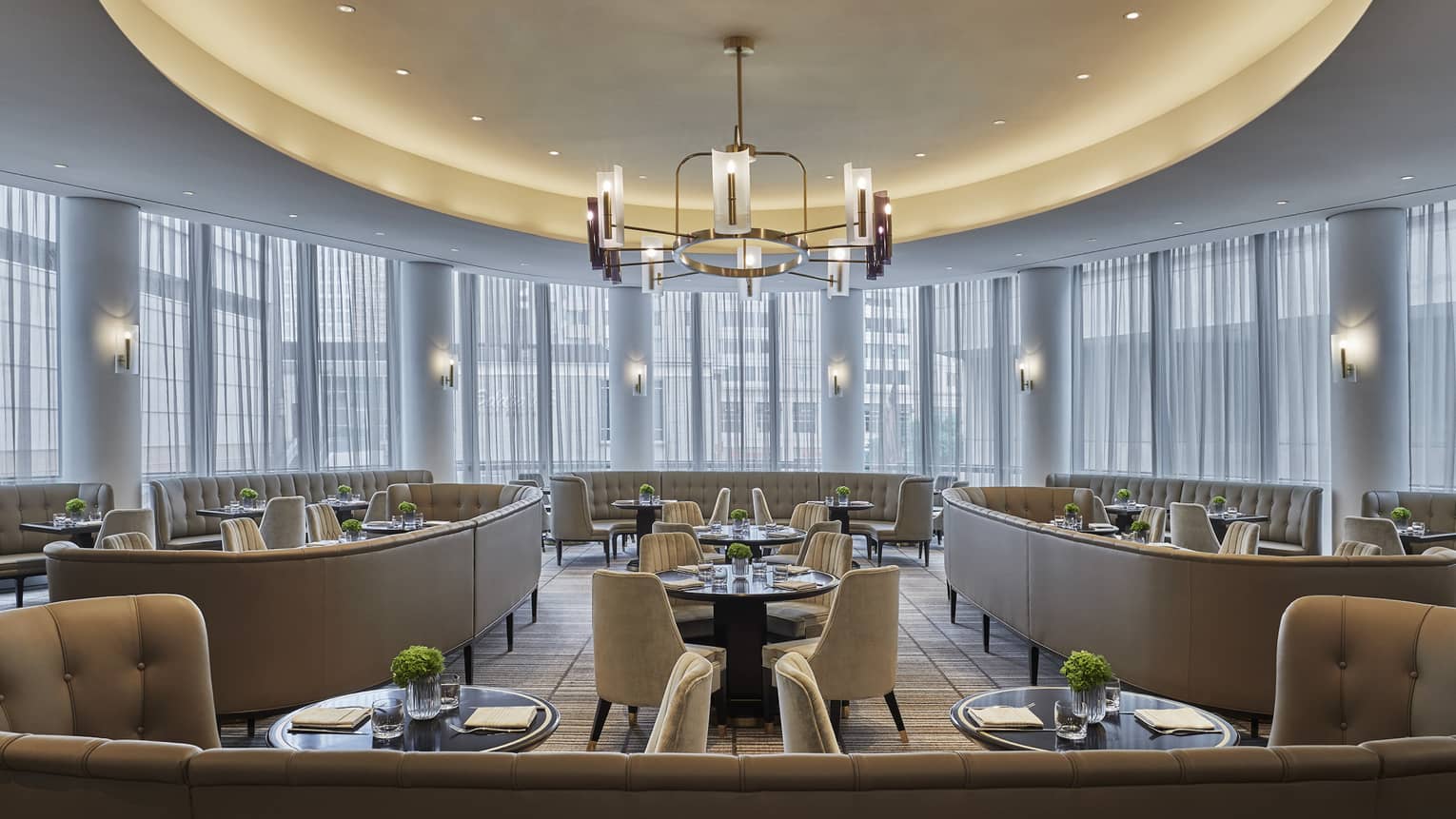 One-One restaurant is empty, but ready with guests, with tables set with menus, plates and greenery