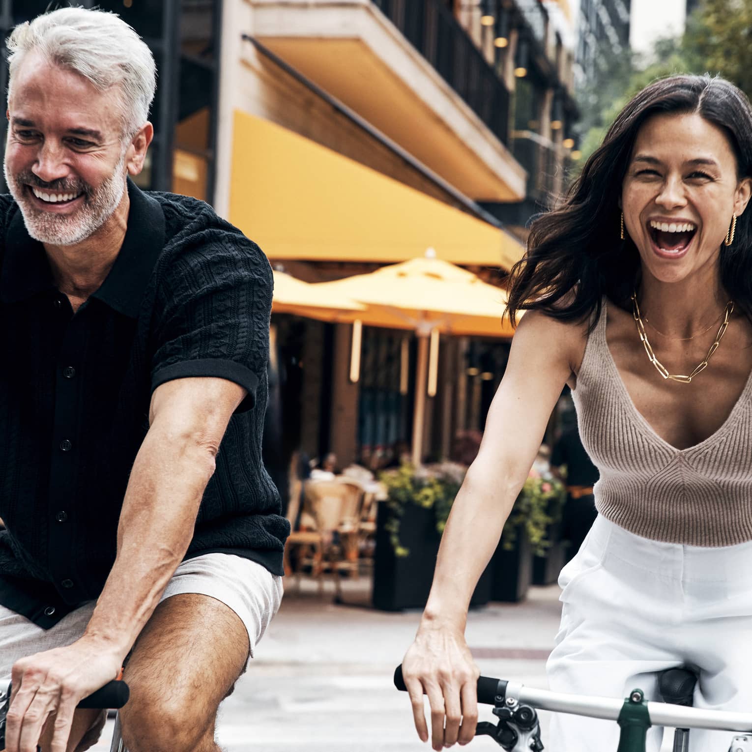 A man and woman riding bicycles.