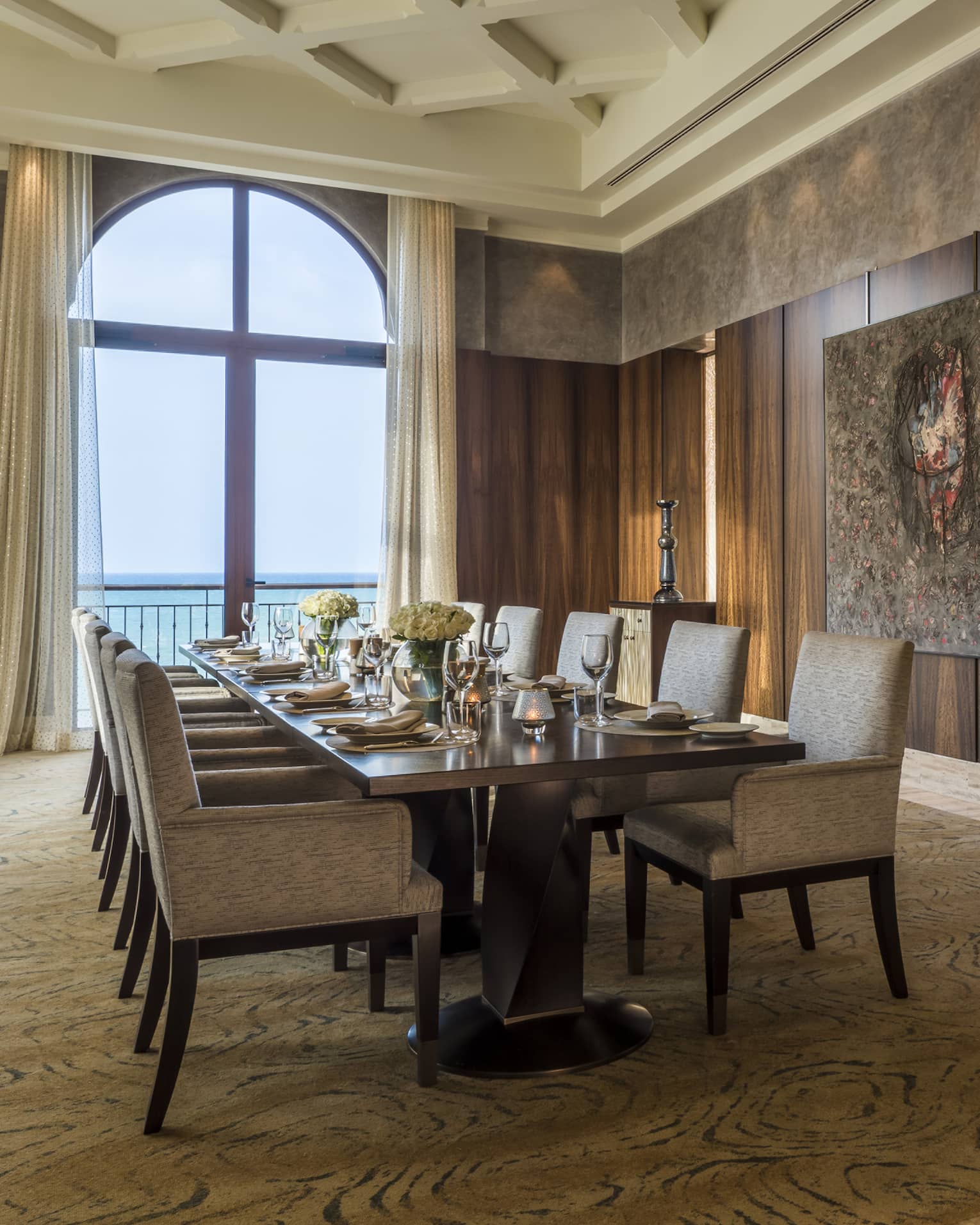 Long dining table in private Creek Bistro dining room, wood paneled walls, view of ocean