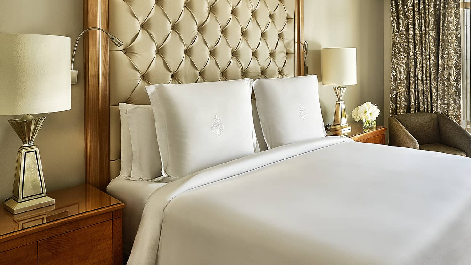 Four Seasons Suite, showing white-dressed bed and city views from windows
