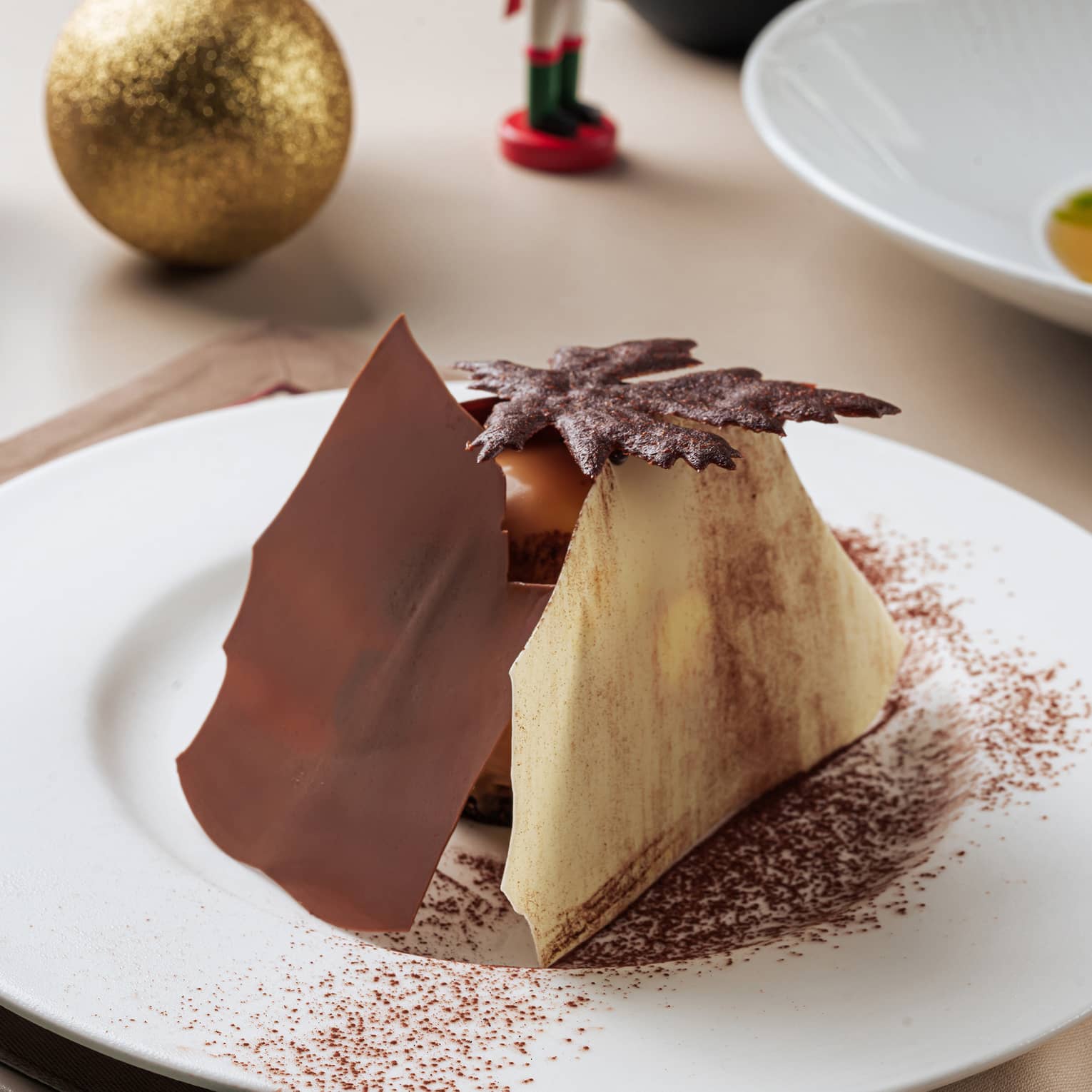 Dessert with two large sheets of chocolate, one dark one white, all on a white plate