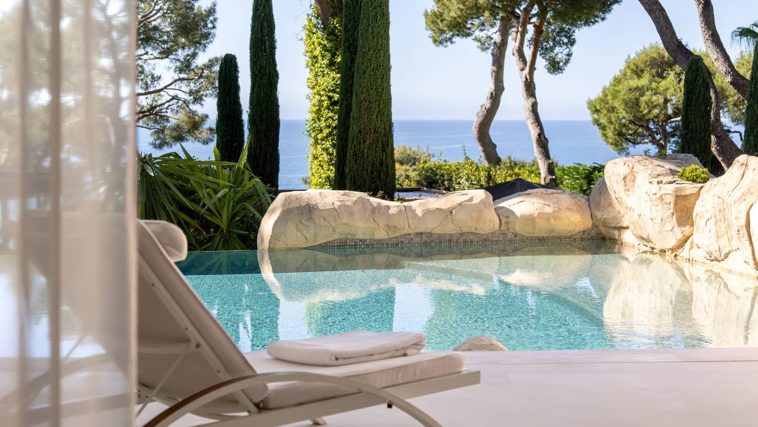 Luxury hotel suite with private pool, surrounded by gardens and with sea view