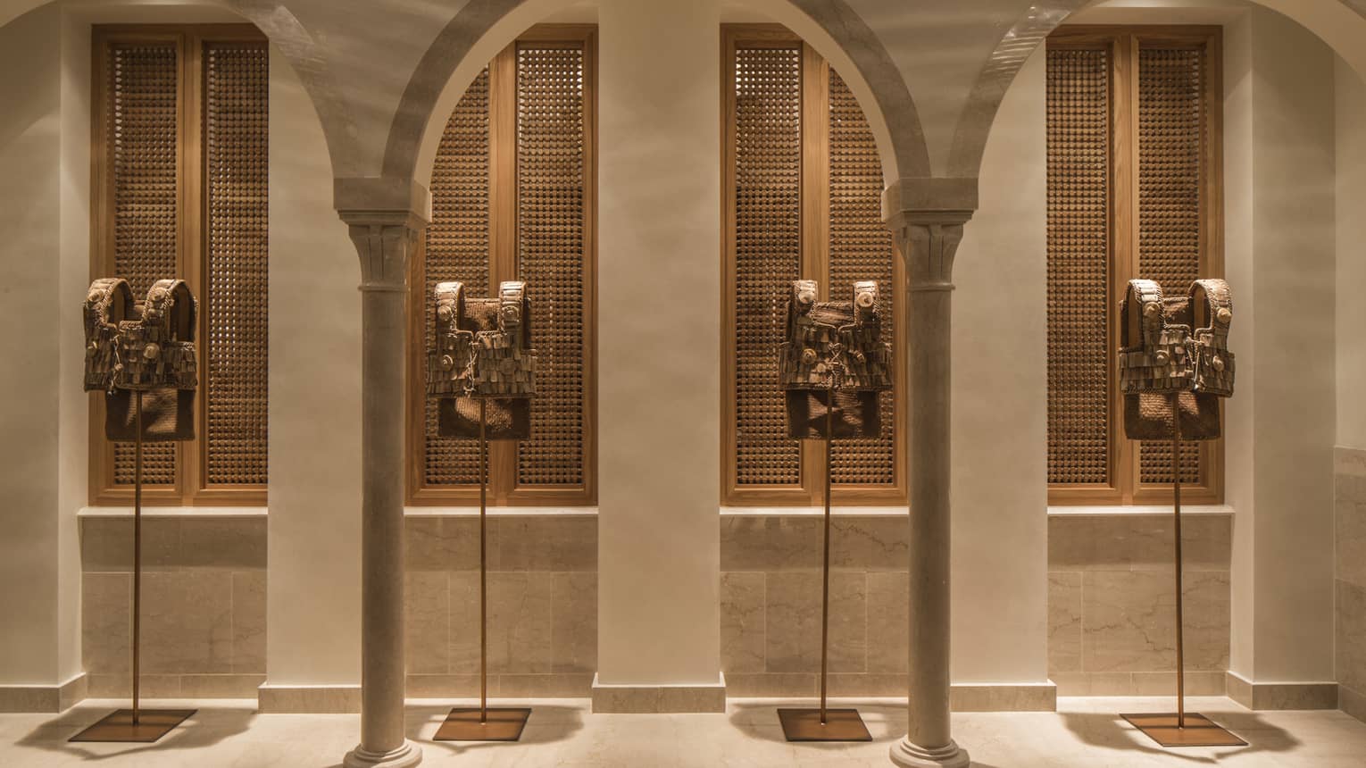 Hallway with tall stone archways and shutters in backdrop