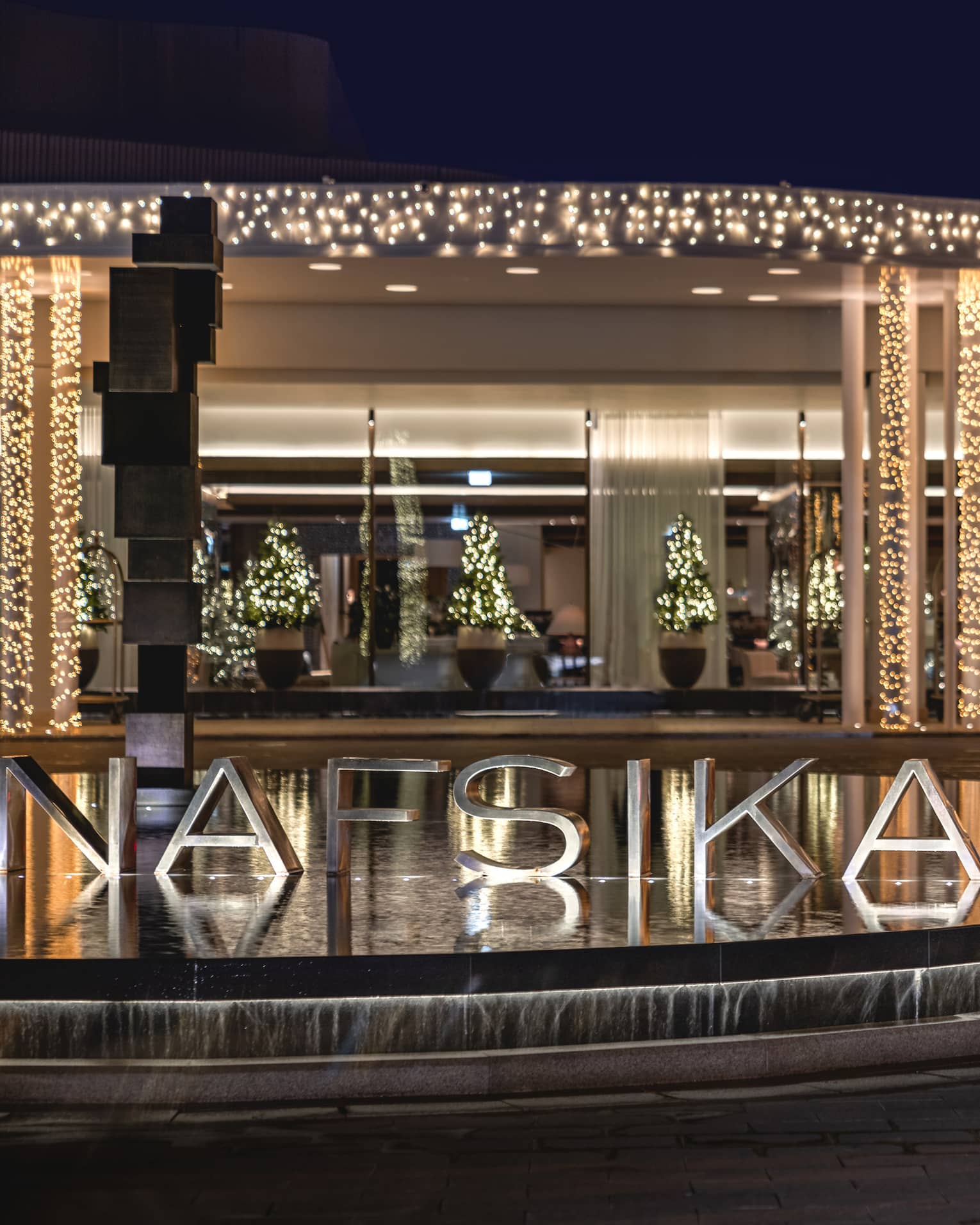 Four Seasons Hotel Astir Palace Athens Nafsika building front entrance illuminated with white holiday lights