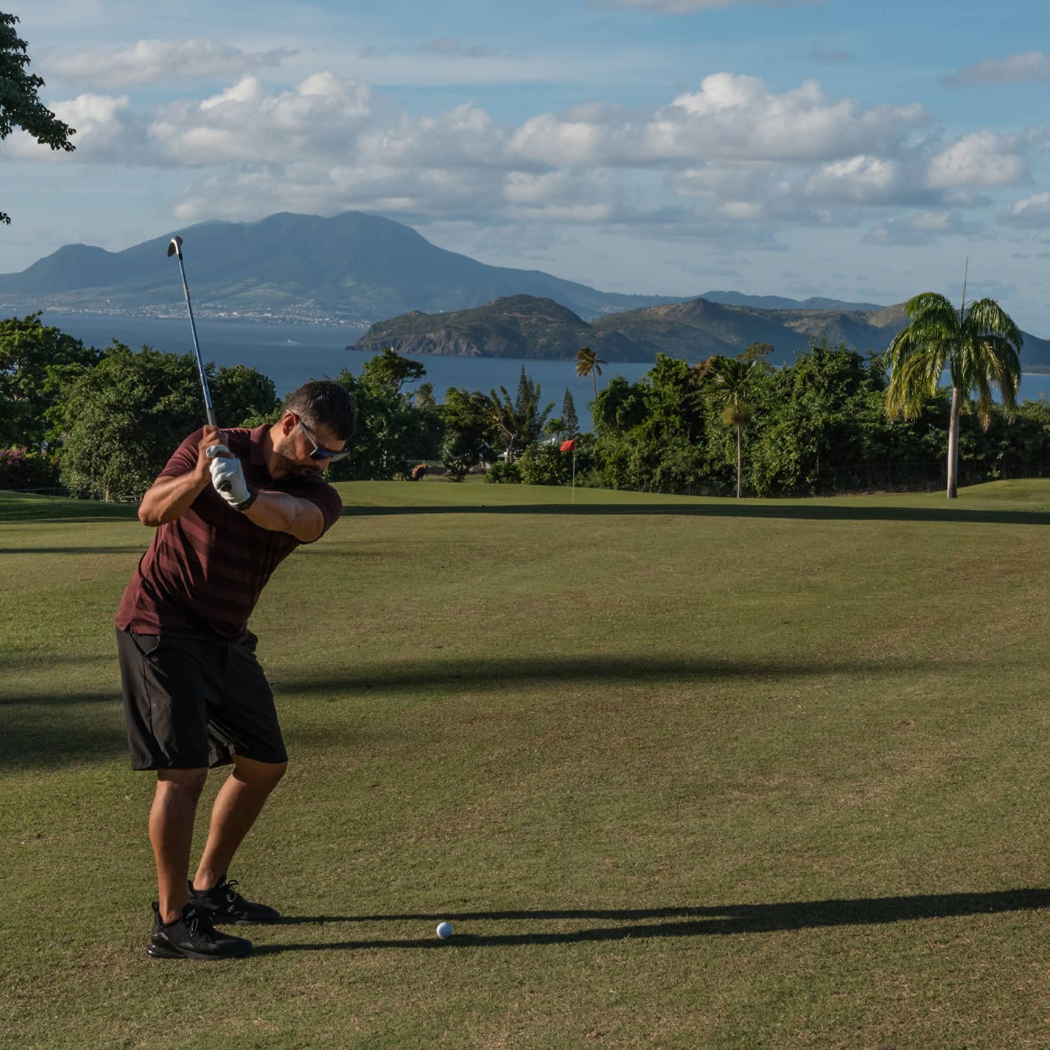 A person swinging a golf club on a golf course