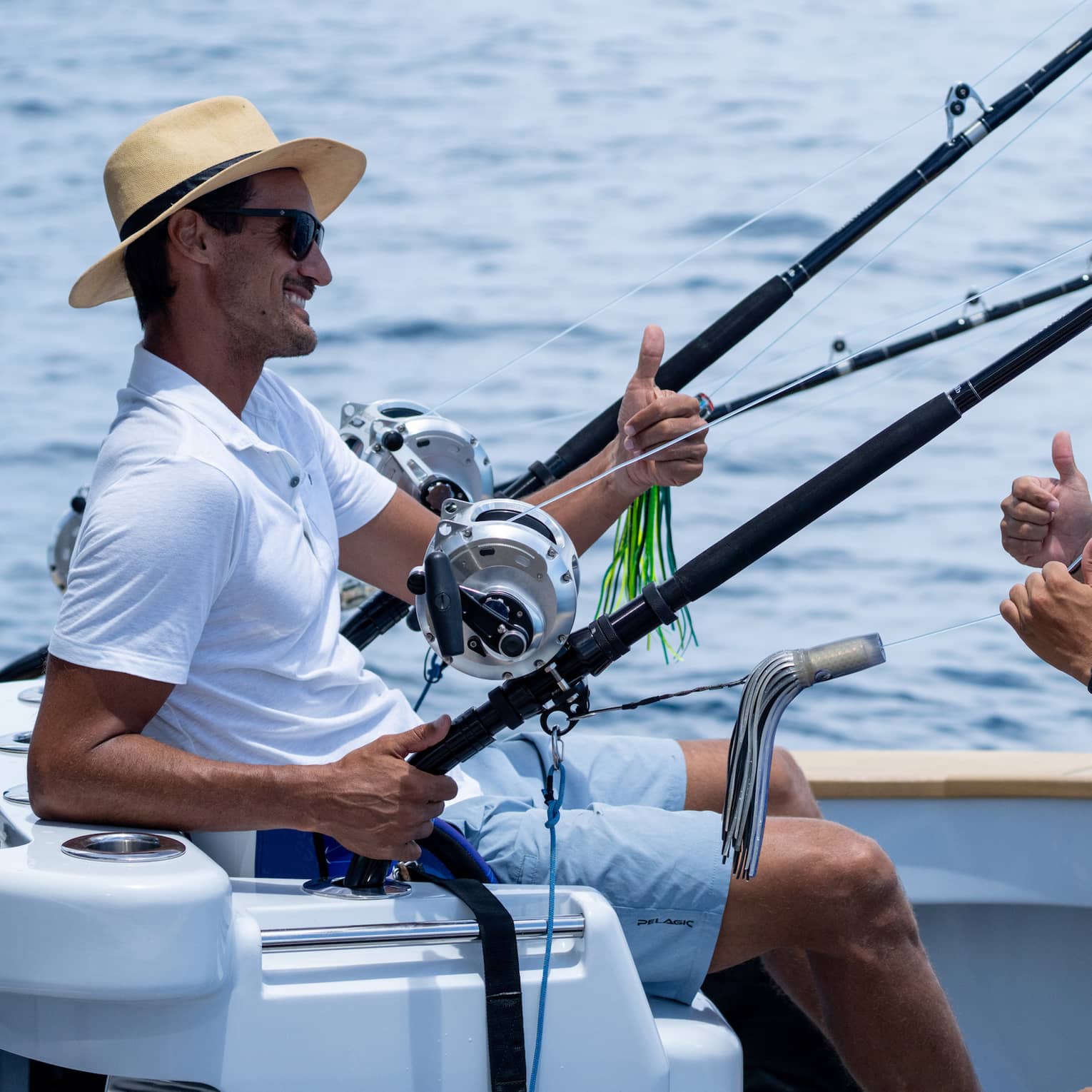 Two men talk on a fishing boat at sea