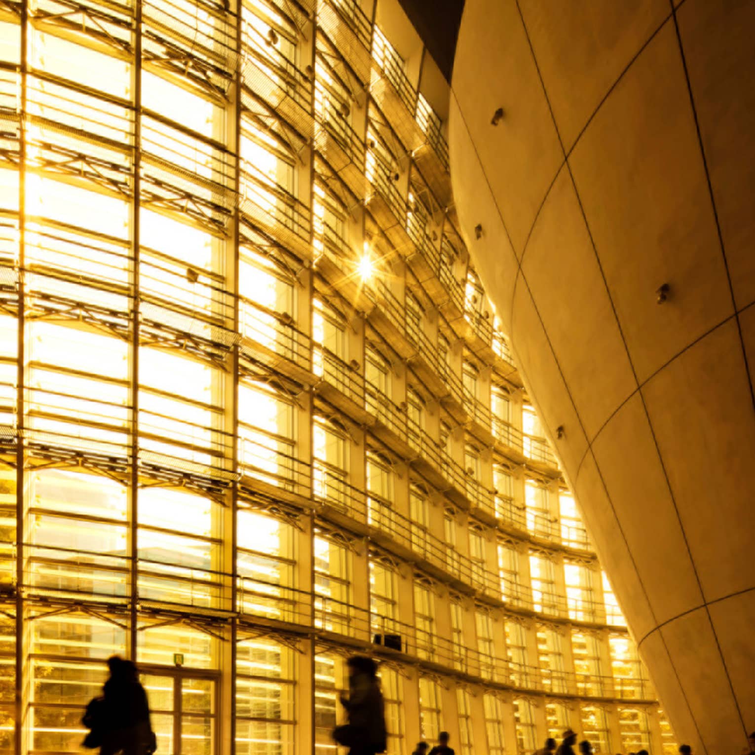 People on their daily commute to work next buildings by architecture Kengo Kuma