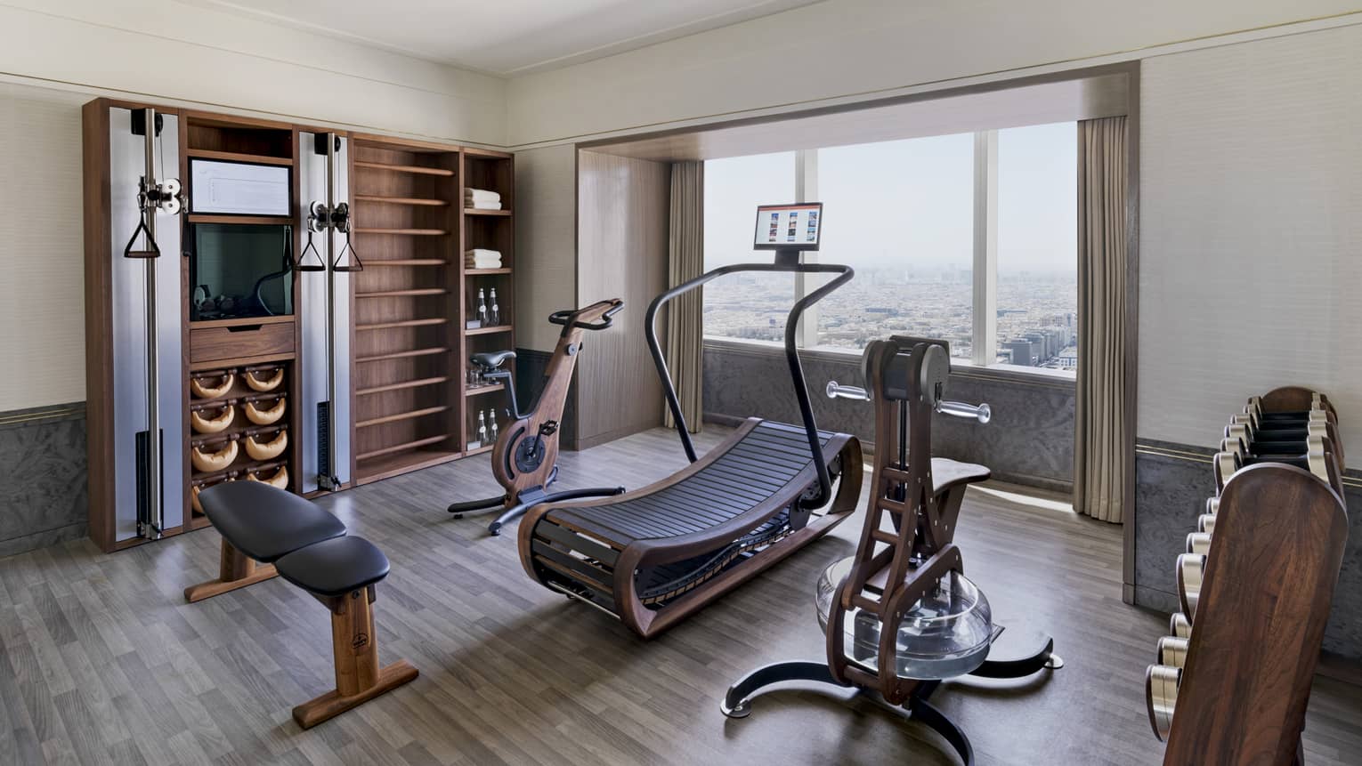 Private fitness room with treadmill, bike, bench and weights