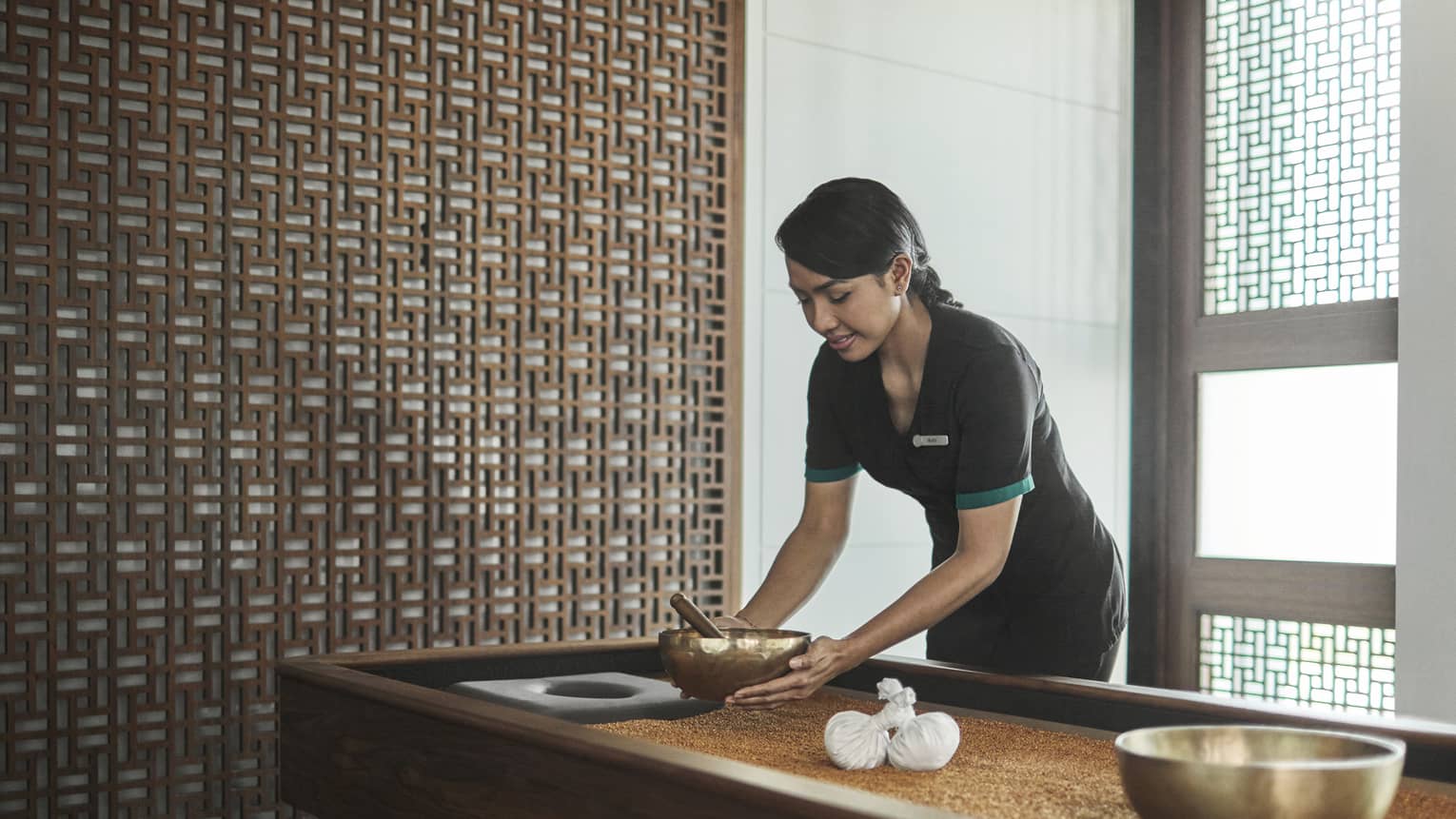 Pear Spa staff places copper bowl on table