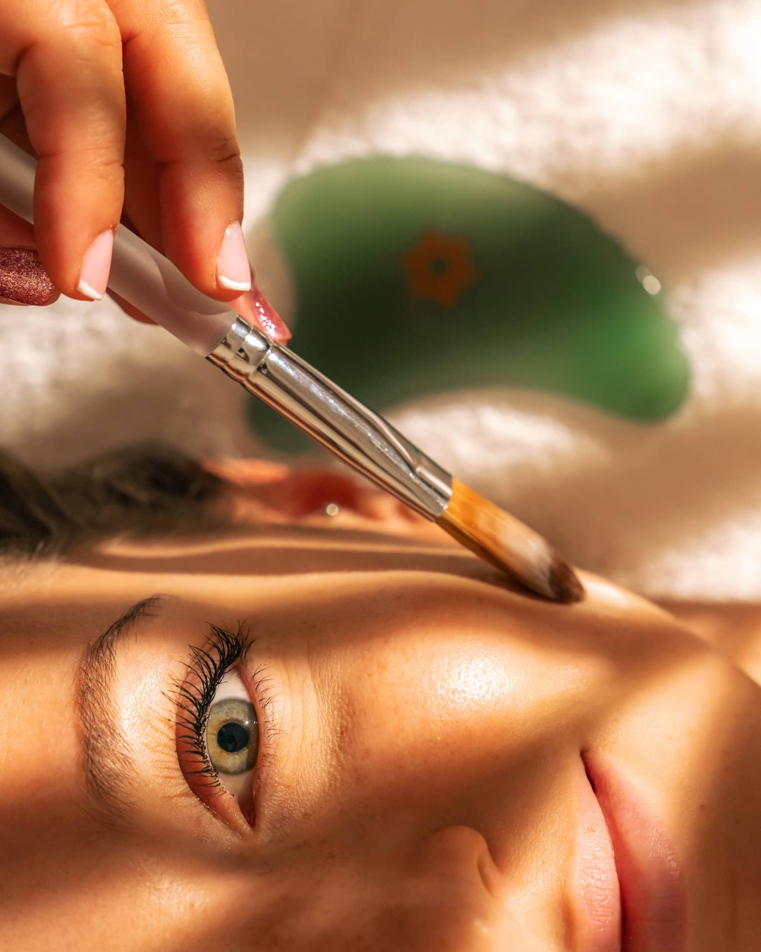 Close up of person's face being brushed